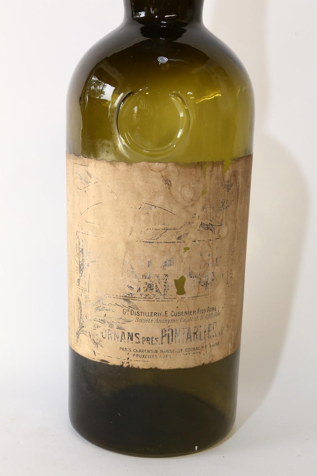 This beautiful large French wine bottle was probably once used as a display or advertising piece. The paper label is worn and aged in places but does read: Gde. Distillerie E. Cusenier Fils Aine, Societe Anonyme Capital 10.000.000, Ornans Pres
