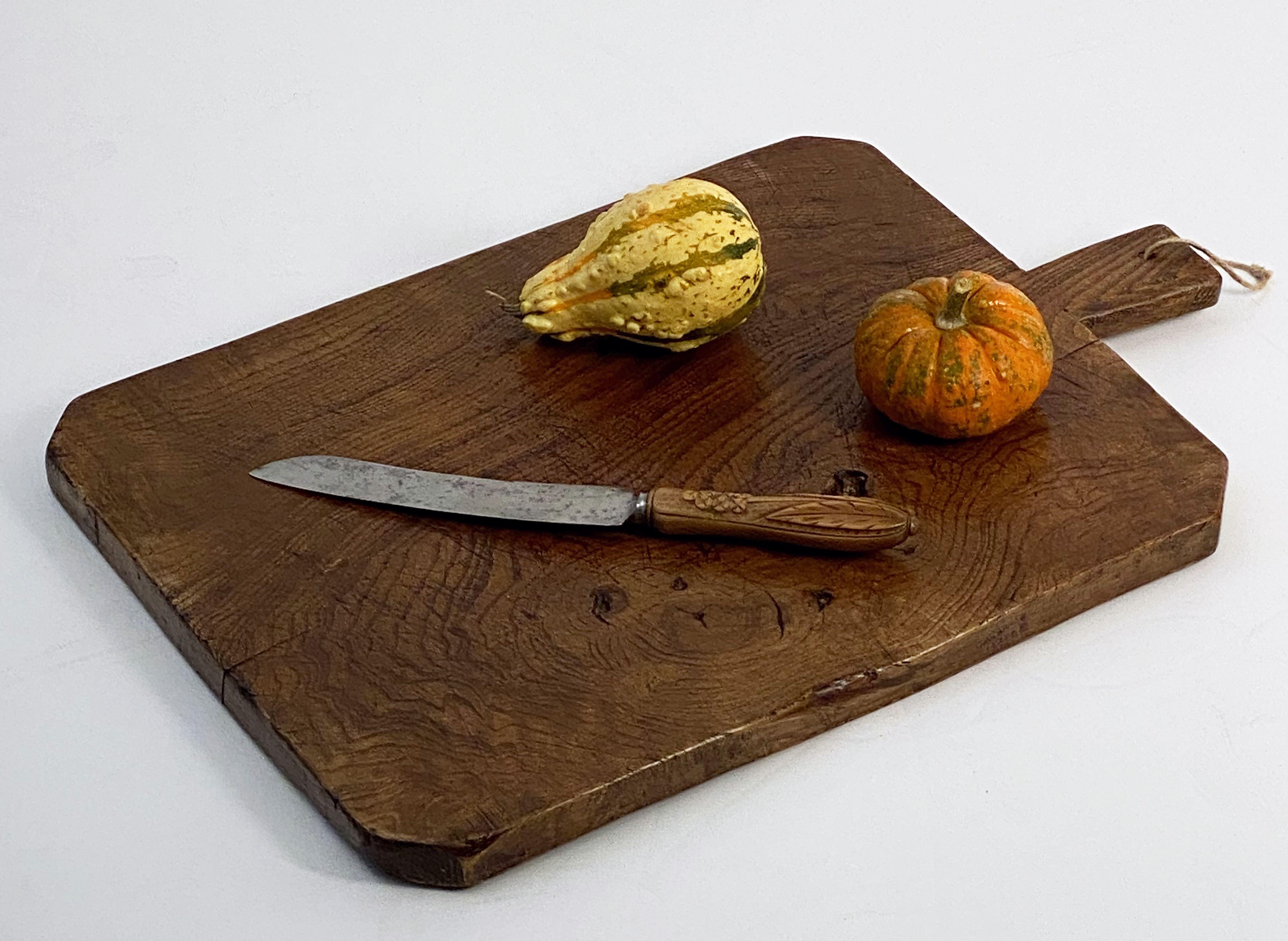 A fine French rectangular cheese or charcuterie cutting or presentation board of patinated wood with handle.

 