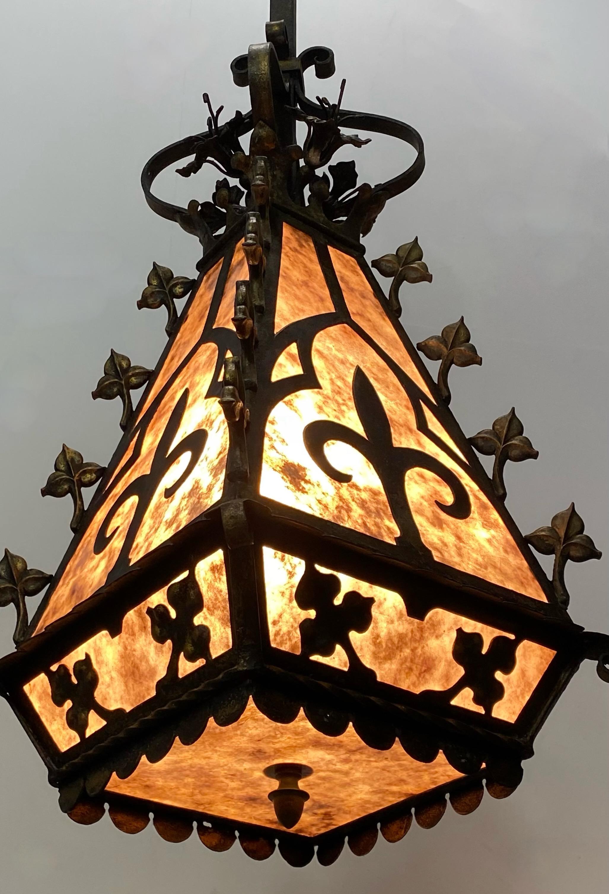 A large wrought iron hanging church lantern with cast zinc leaf ornaments and mica panels.
France, 19th Century
Recently re-wired and fully restored. For indoor or outdoor use.
The drop length with the chain is 8 feet x 9 inches. We can shorten