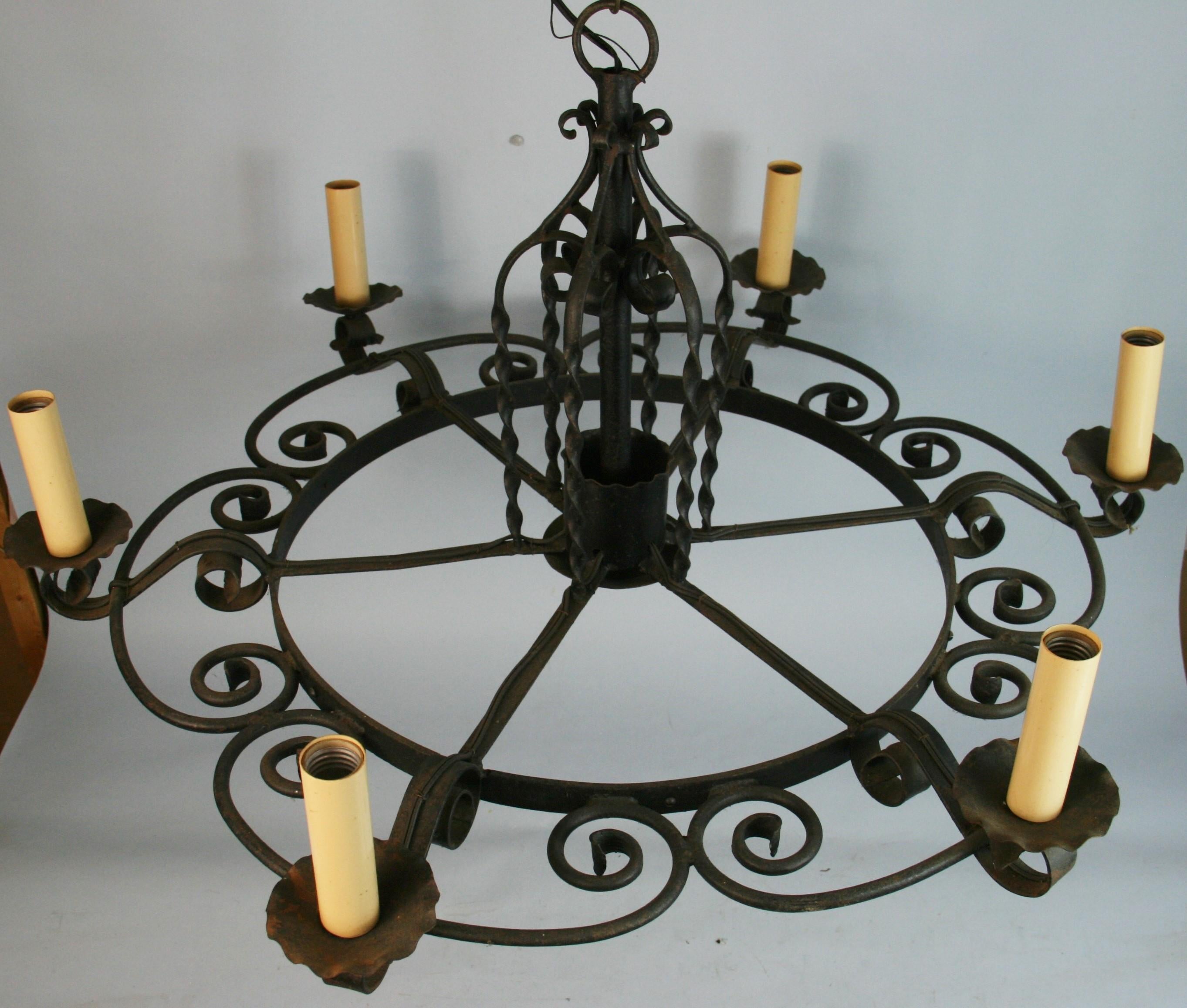 1610 An oversized elegant and rustic all hand forged iron hoop with cage form center stem and scrolled iron work around the hoop.
Rewired 
Takes 60 watt Edison based bulbs
  