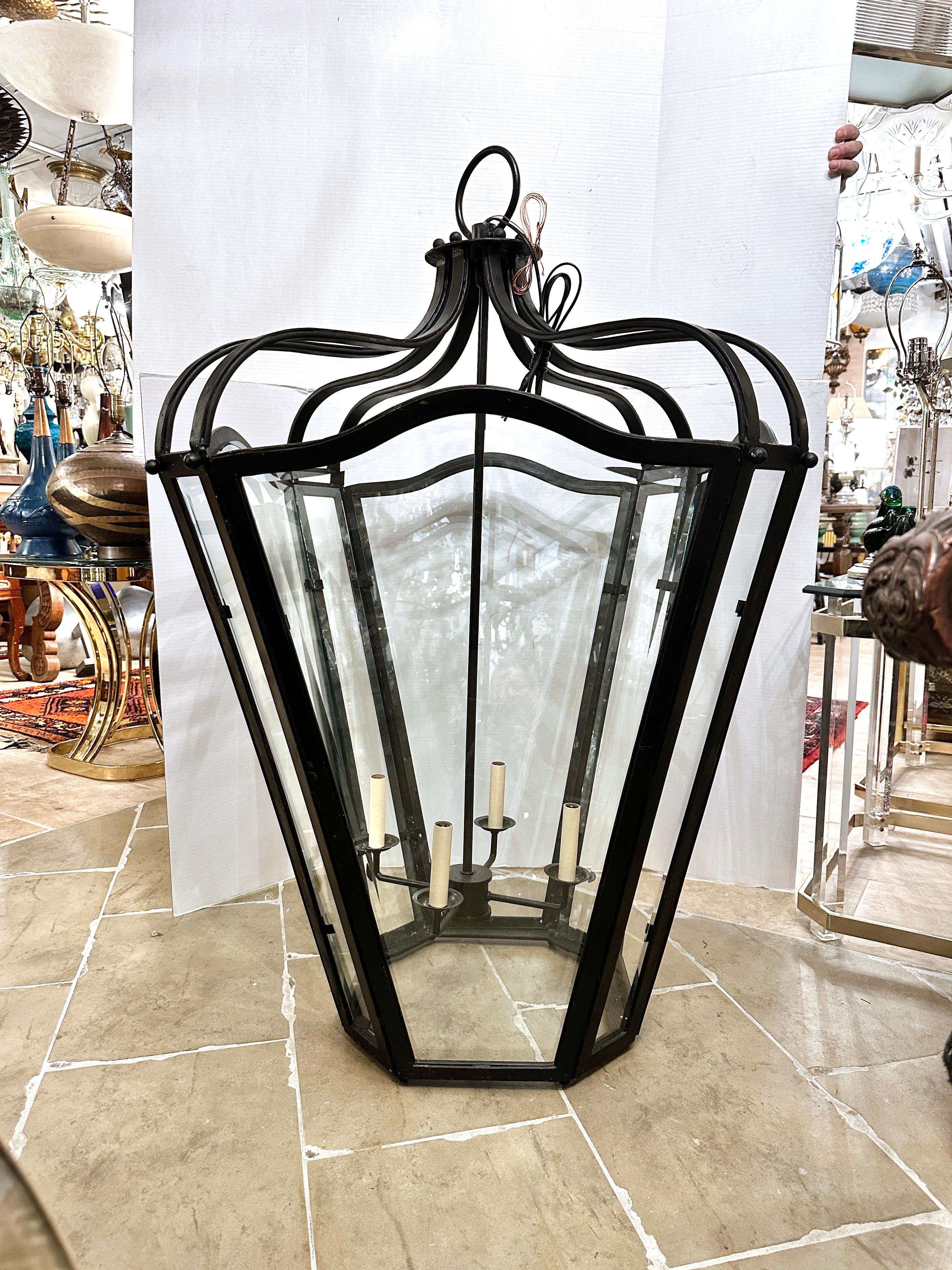 A circa 1950's French wrought iron lantern with beveled glass panels.

Measurements:
Height of body: 46