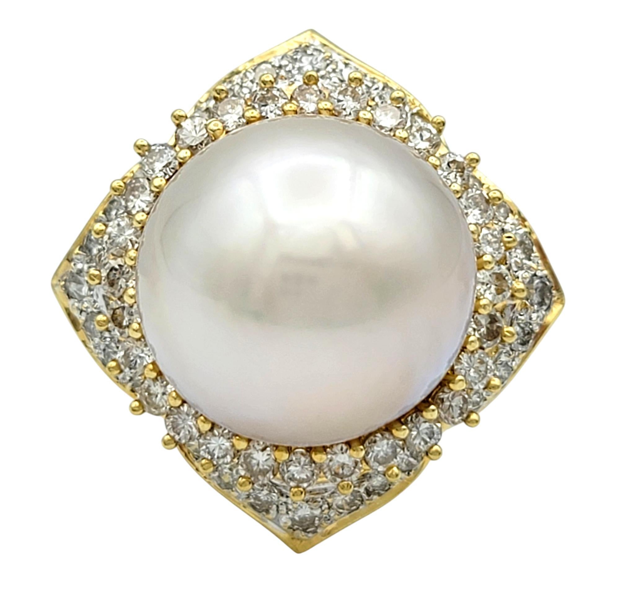Ring Size: 5.5 

This exquisite cocktail ring radiates elegance and sophistication, featuring a lustrous round pearl as its captivating centerpiece. The pearl, with its soft iridescent sheen, is beautifully encircled by a halo of brilliant diamonds,