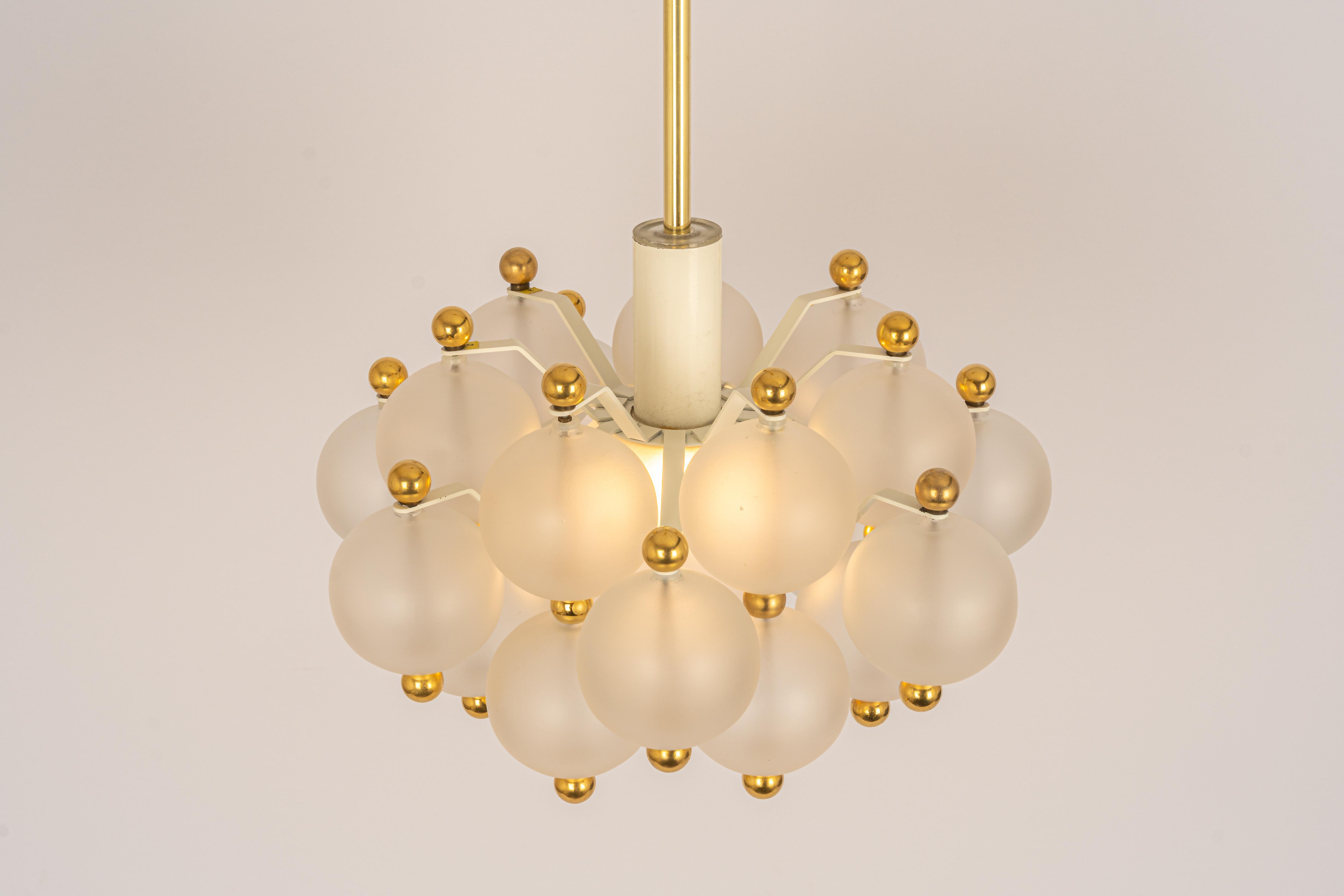 A stunning frosted glass and brass chandelier by Kinkeldey, Germany, 1970s

Sockets: One x E27/E26 standard bulb (100 Watt), and it function on voltage from 110 till 240 volts.
Light bulbs are not included. It is possible to install this fixture