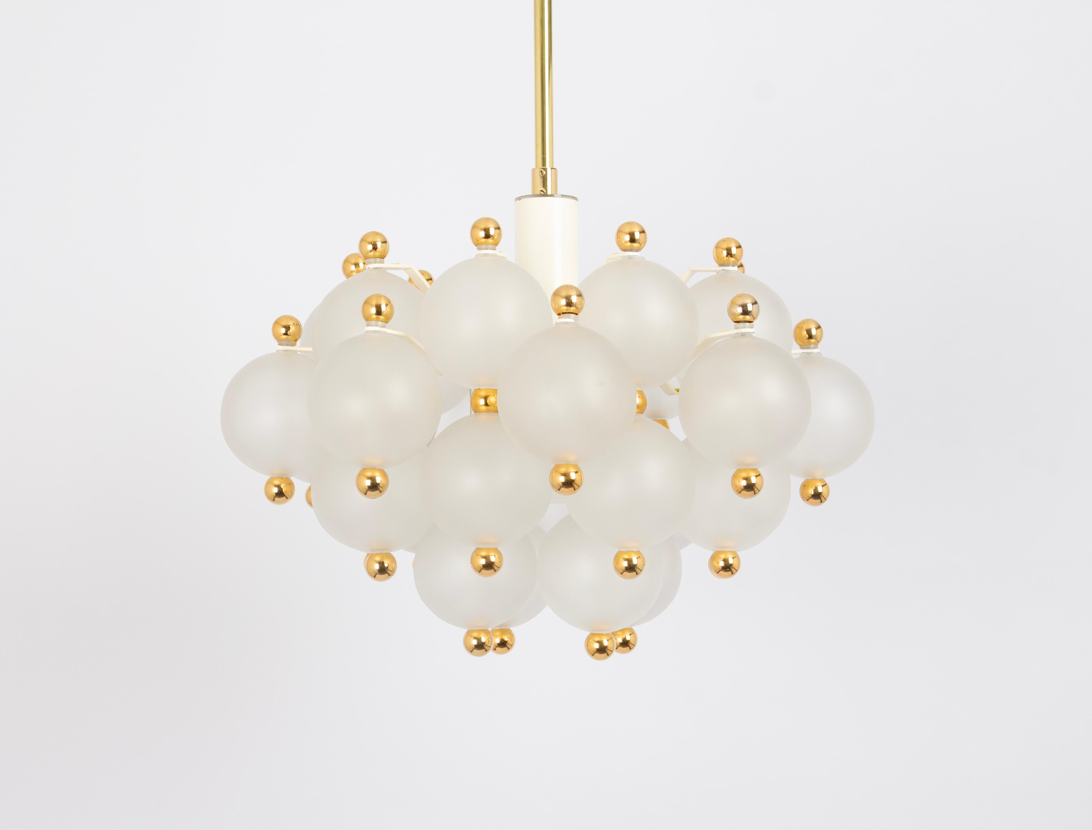A stunning frosted glass and brass chandelier by Kinkeldey, Germany, 1970s

Sockets: One x E27/E26 standard bulb (up to 100 Watt)
Light bulbs are not included. It is possible to install this fixture in all countries (US, UK, Europe, Asia,