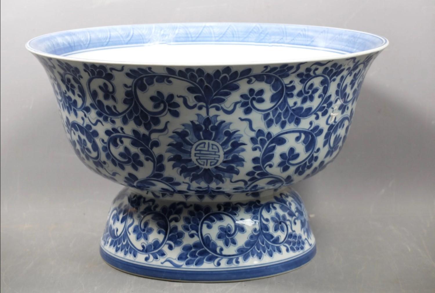 Very beautiful large white-blue porcelain basin or fruit bowl or cup. The large white bowl is decorated with a blue floral-themed composition, including foliage, lotus flowers and magnolias and an Asian sign. The belly flares towards the edge.
The
