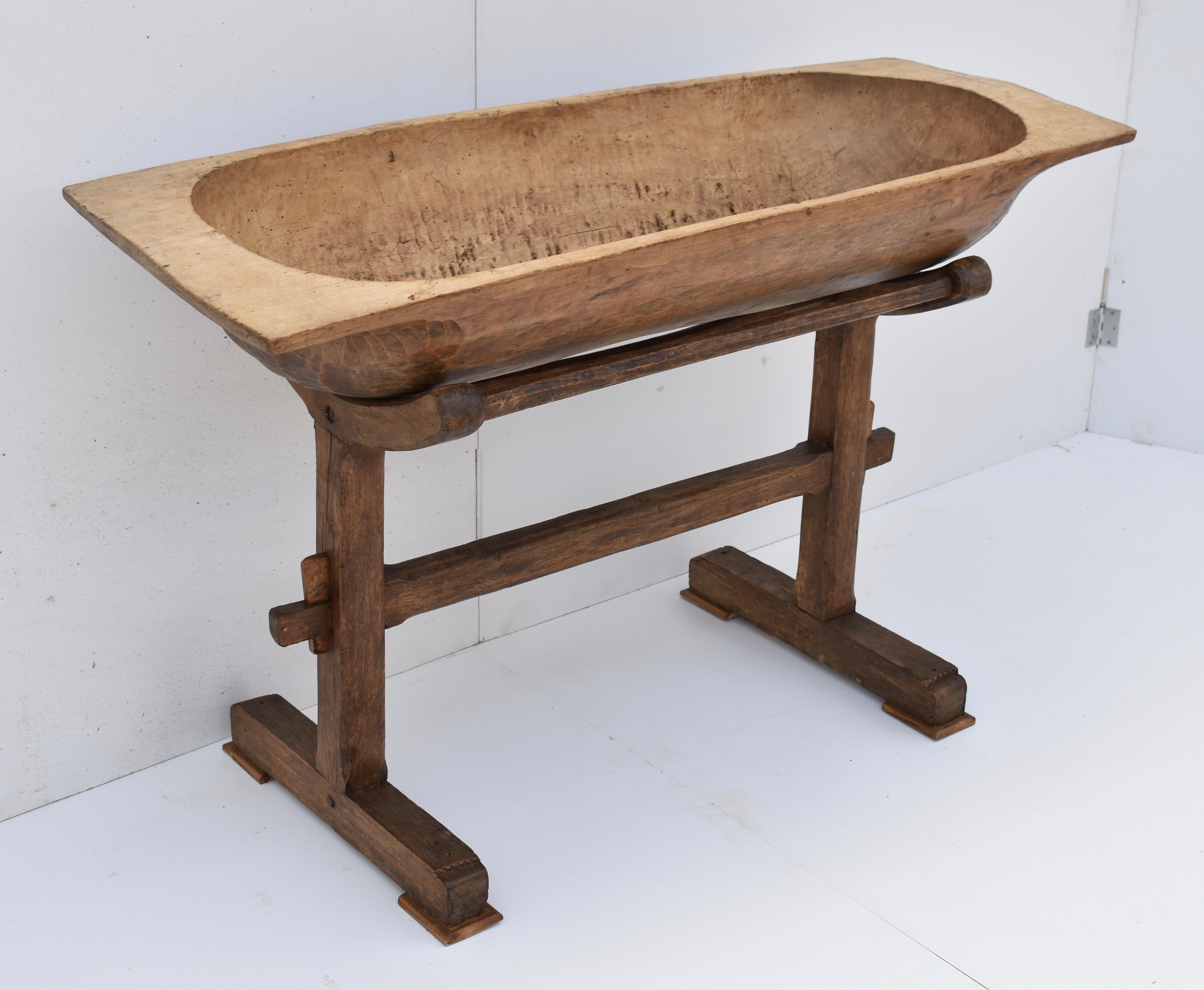 Used for kneading dough for multi-family baking or perhaps for washing the baby, this large fruitwood trog was hand-hewn from a single split log. It has developed a slight twist over the years but its rounded bottom sits nicely in the curved