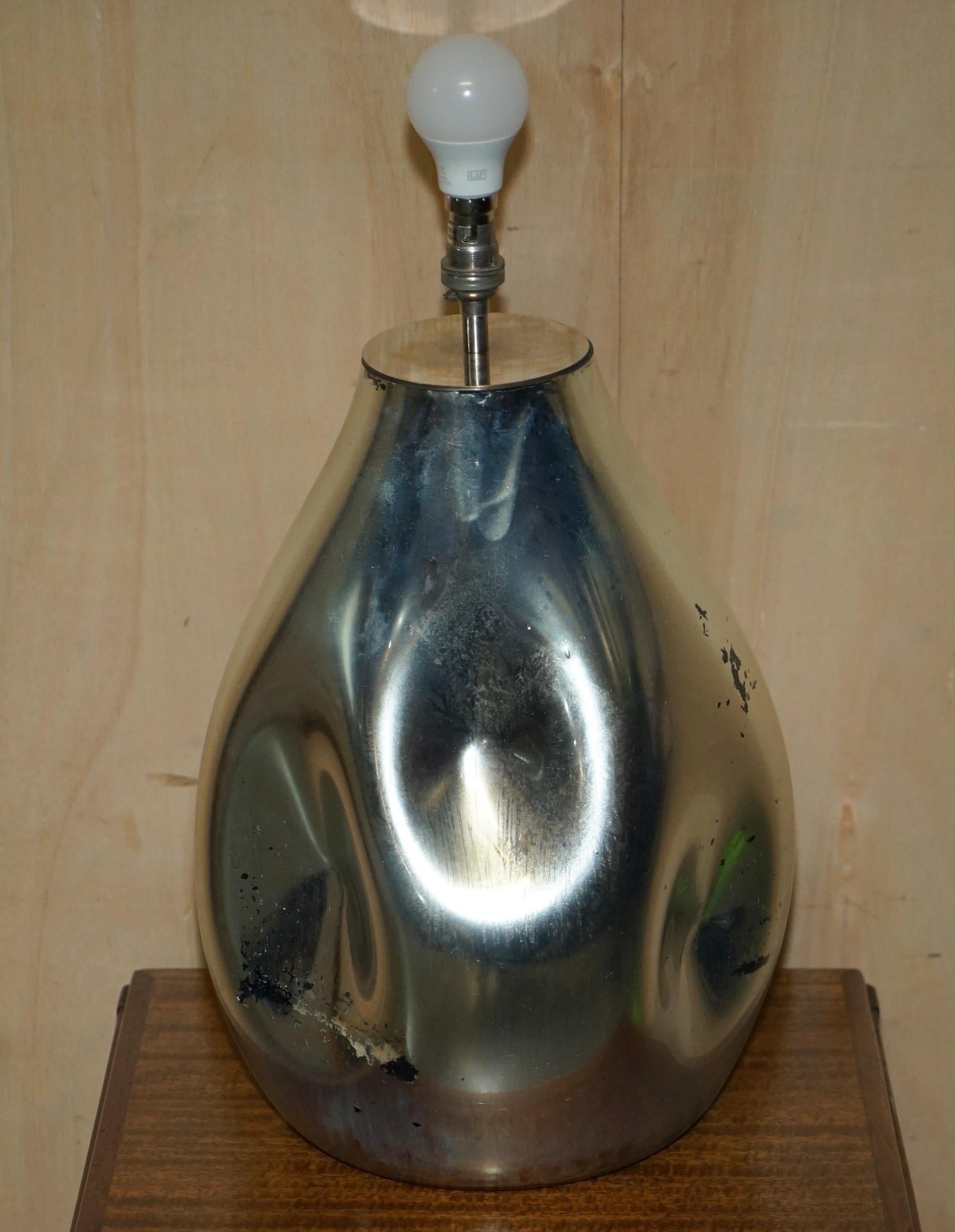 We are delighted to offer for sale this stunning vintage mirrored foxed glass large artistic sculptural table lamp

This lamp is solid mirrored glass which due to age, has some very desirable foxing in places, it looks like metal but is pure