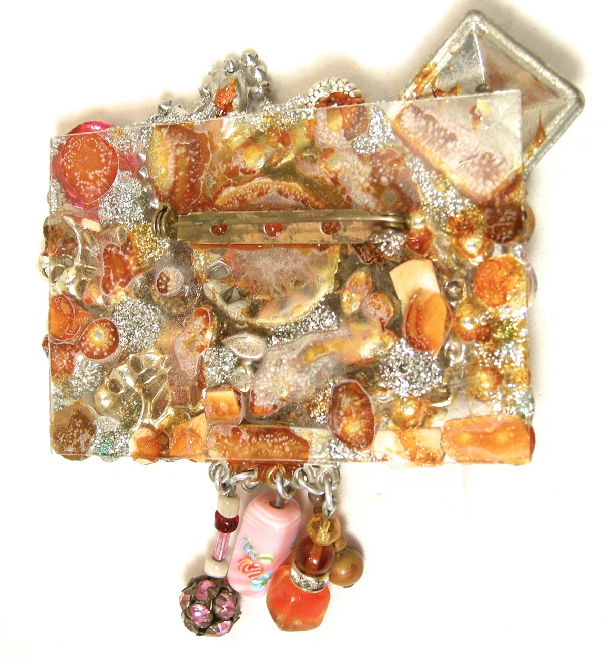 This large, fun vintage brooch is quite impressive and obviously hand crafted with multi-color crystals and beads on a clear Lucite backing. It has a turn-pin clasp.  In excellent condition, this brooch measures 3-1/2” x 3-3/4”.