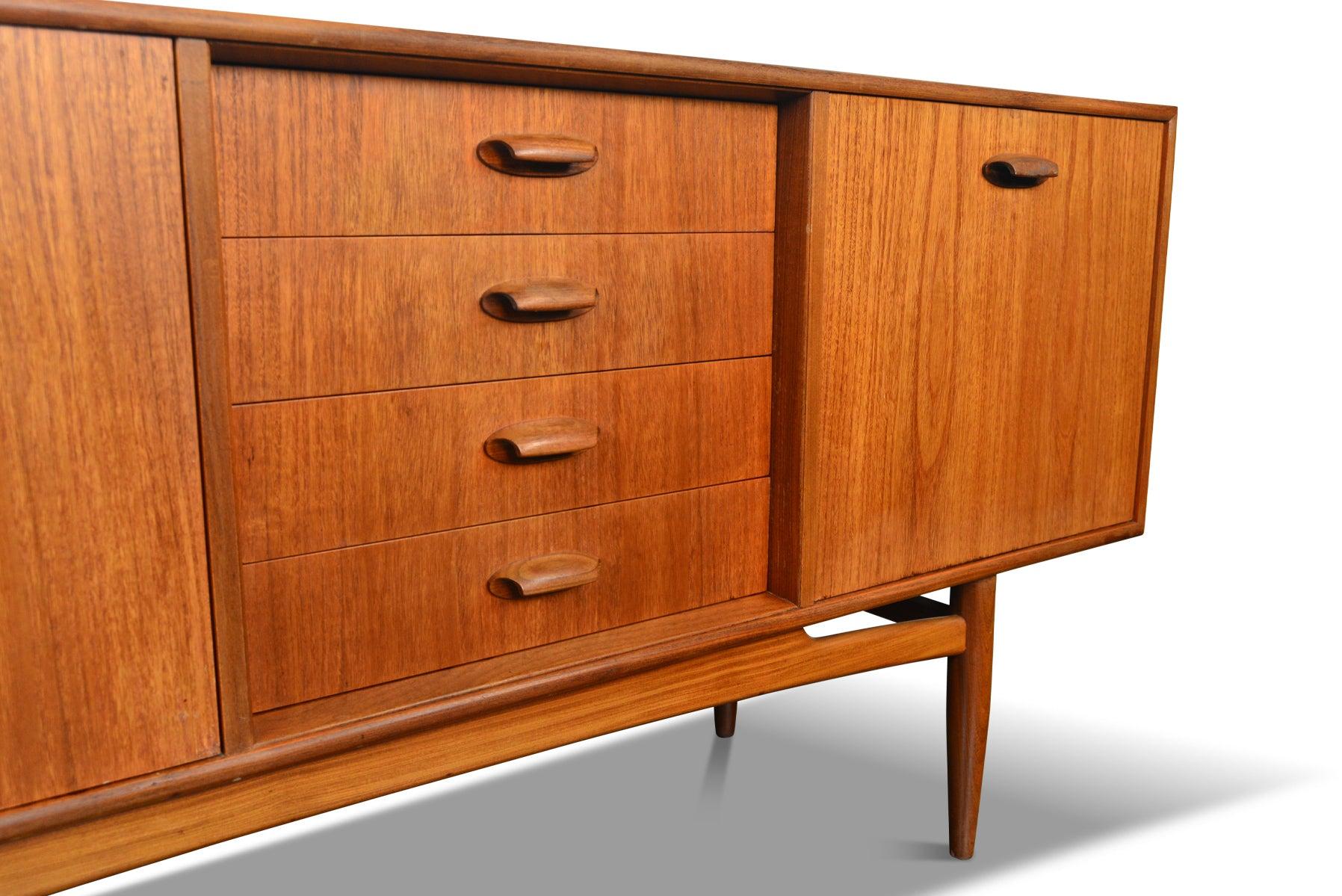 Origin: England
Designer: Victor B. Wilkins
Manufacturer: G Plan
Era: 1964
Materials: Teak, Afromosia
Measurements: 81? wide x 18? deep x 31? tall 

Condition: In excellent original condition with typical wear for its vintage. Price includes