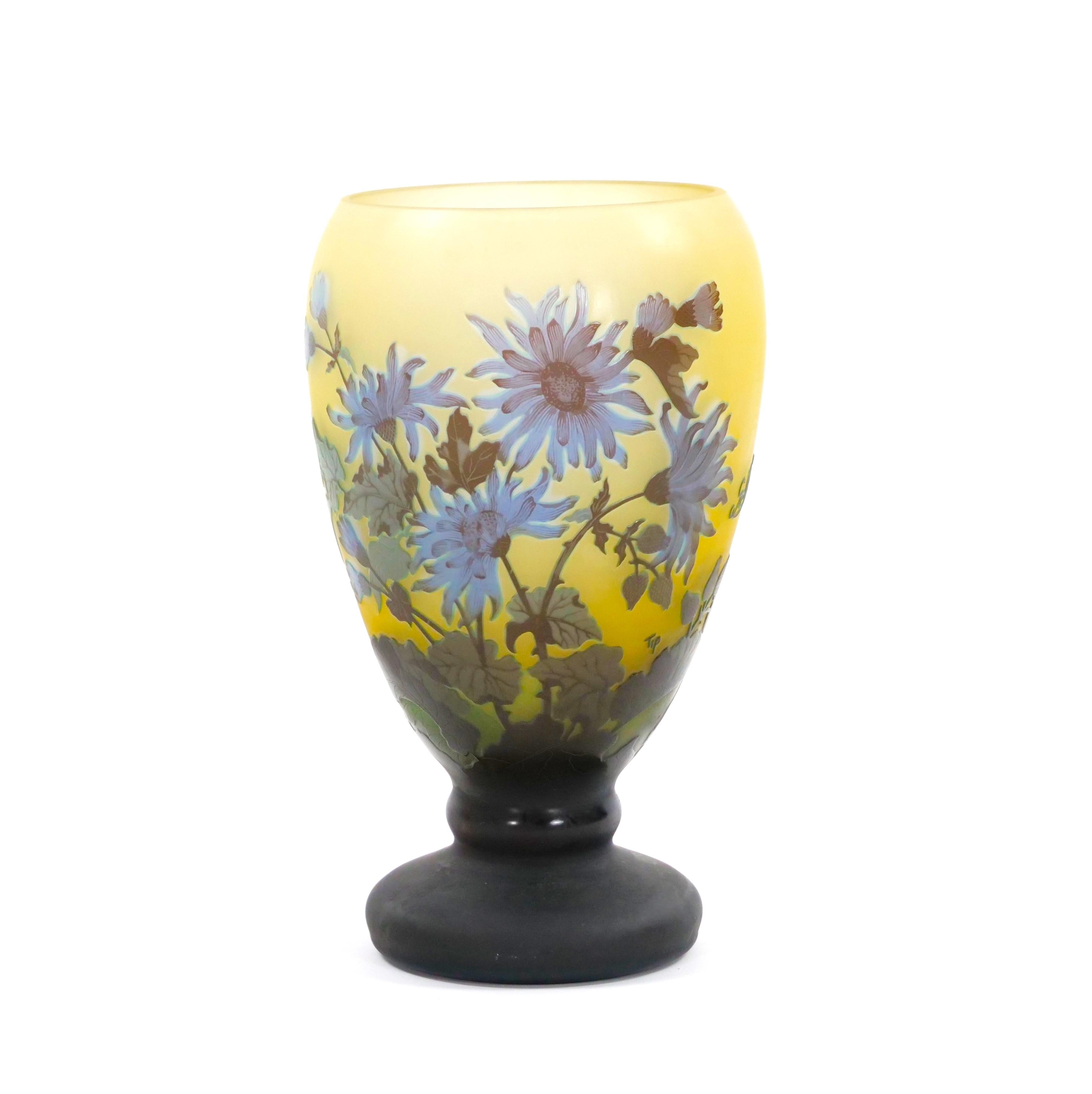 Beautiful and large footed cameo glass vase in the Art Nouveau style depicting blooming blue violet flowers on a pale yellow ground. Signed Galle.  12 1/2 by 7 inches.