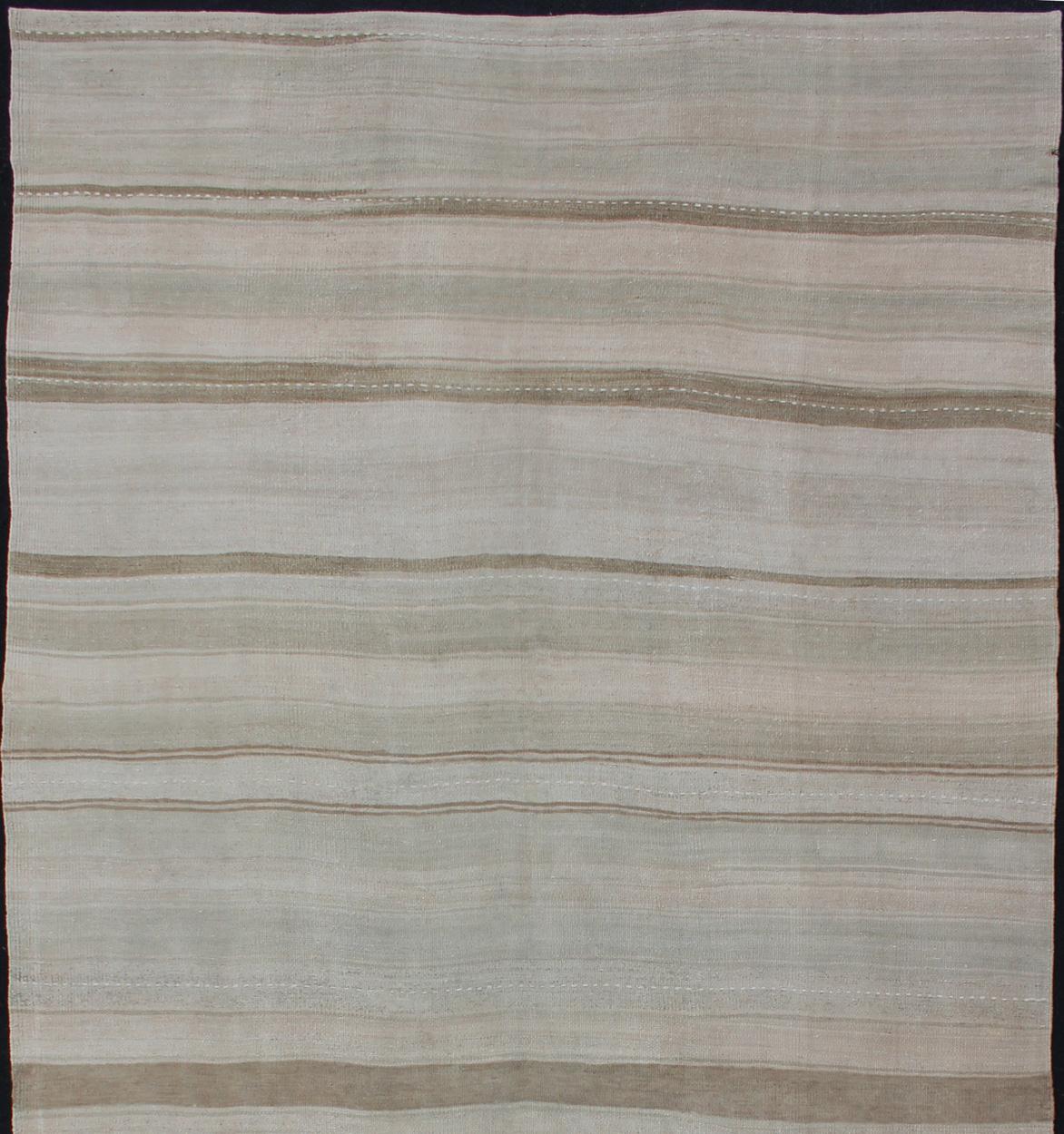 Stripe design Kilim Gallery rug / runner in cream and taupe light camel and neutrals, rug EN-176882, country of origin / type: Turkey / Kilim, circa 1950

This flat-woven Kilim gallery runner from Turkey features a neutral composition consisting
