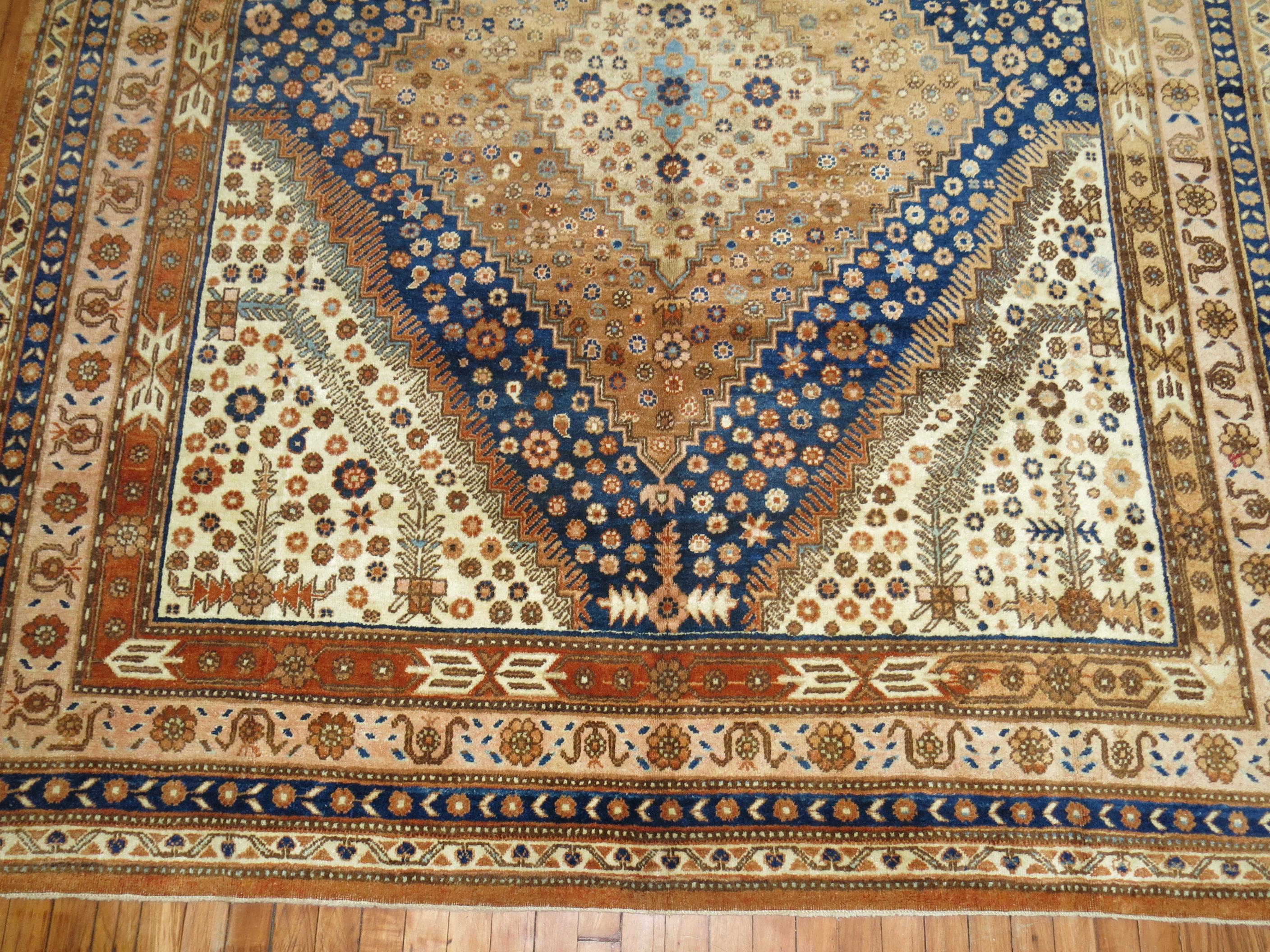 Large Gallery Size Khotan rug from the middle of the century with a geometric design in deep blue, burnt orange, and apricot accents

Measures: 7'2'' x 14'