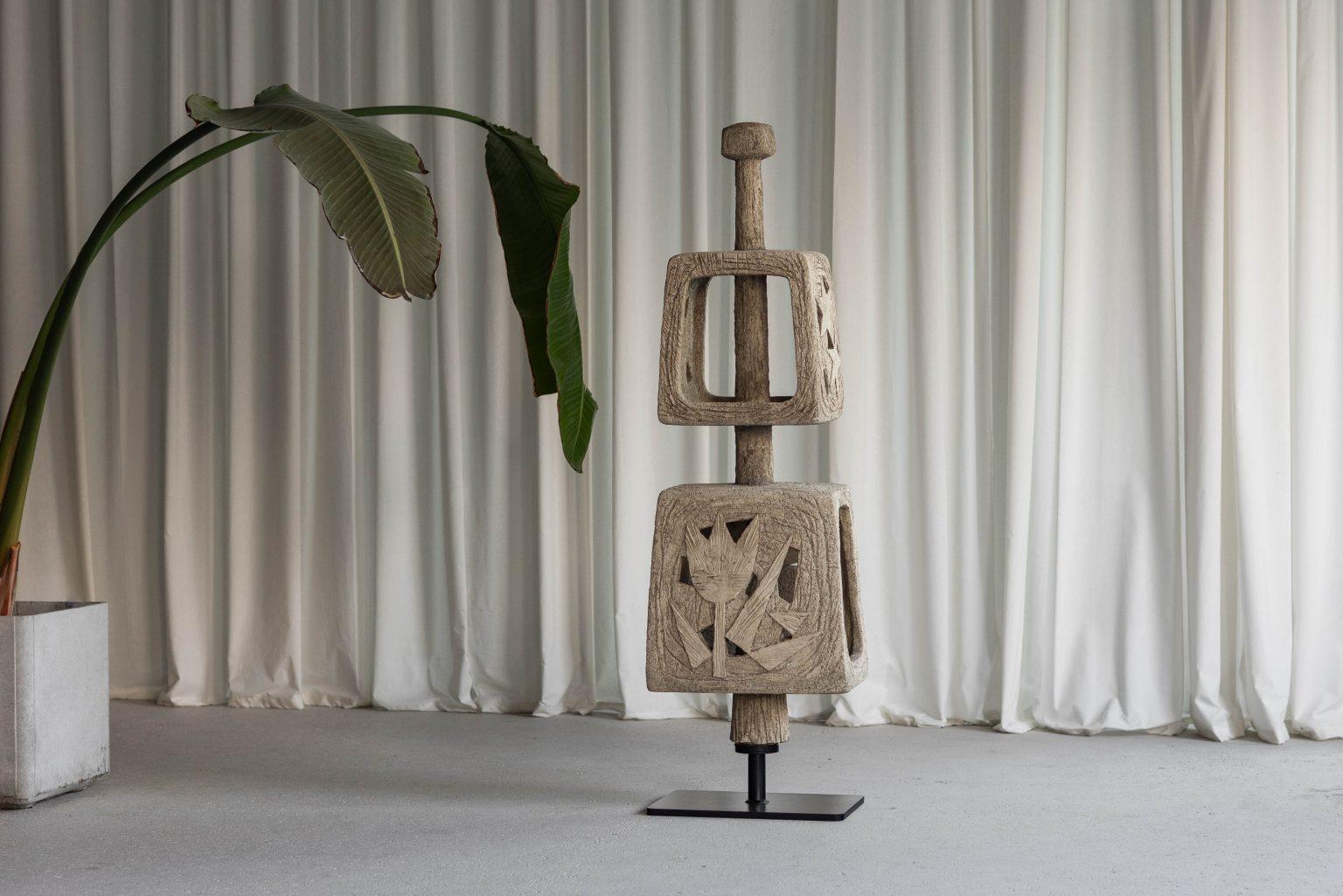 This outdoor sculpture, created in France during the 1960s, is a captivating example of mid-20th-century abstract art. It features two hollow, cube-like structures stacked vertically, separated by a central pole, and mounted on a sleek, custom-made