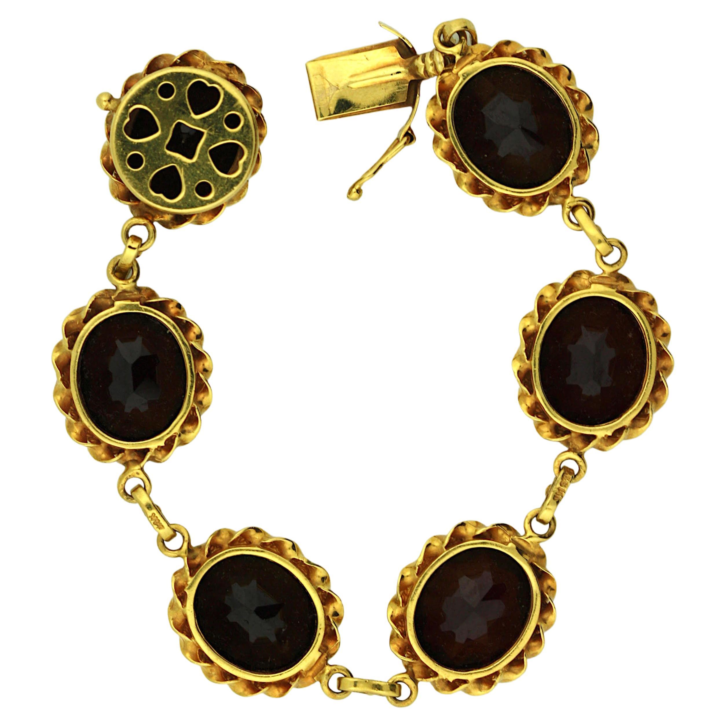 Estate nice and heavy 14K yellow gold bracelet, designed with 7 large natural oval cut garnet stone about 12mm x10mm. marked 14KG. weight about 31 grams. We also offer clip on earring matching the bracelet.