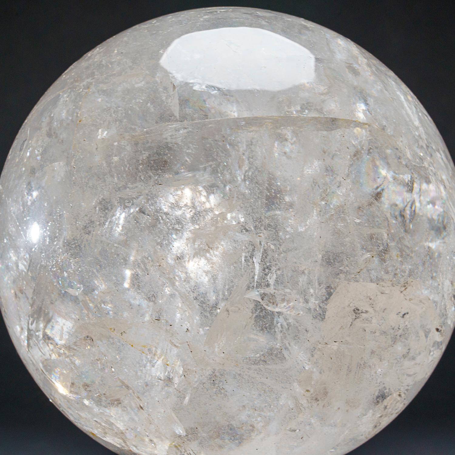 This museum quality large polished Clear Quartz sphere from Brazil. This sphere boasts a weight of 34lbs and has been expertly polished to a high level of transparency and reflectivity, making it an excellent specimen for metaphysical use. It is a