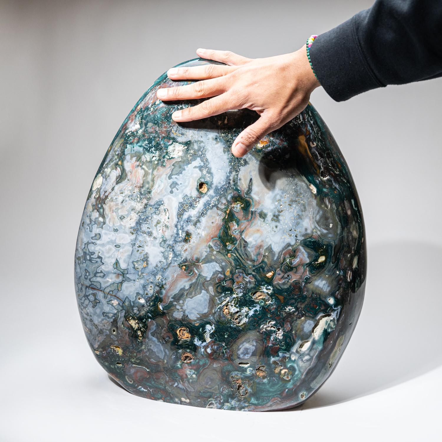 Museum quality, huge hand-polished freeform specimen, made from a solid piece of natural Madagascan Ocean Jasper. This large piece has an amazing pattern with beautiful hues of green, red, yellow, and tan. This unique specimen is the perfect