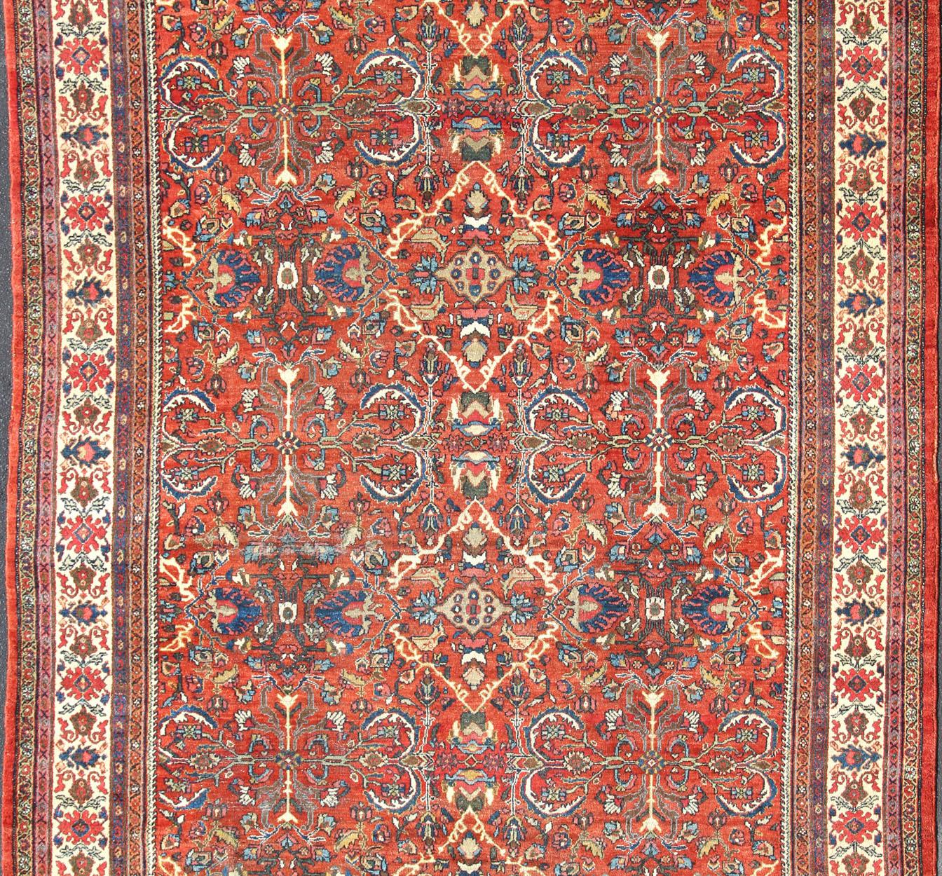 Red background antique Persian Mahal-Sultanabad rug with all-over large flowers. Keivan Woven Arts /  rug R20-0711-50, country of origin / type: Iran / Sultanabad, circa 1920
Measures: 10'10 x 14.
This antique Persian Mahal Sultanabad carpet (circa