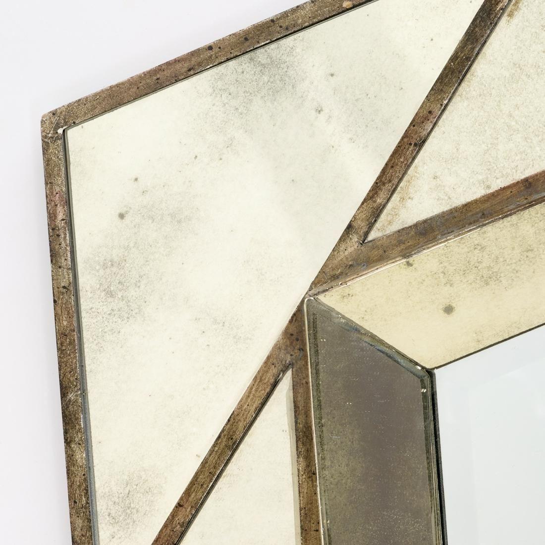 A geometric Venetian style beveled mirror with a faux antiqued finish.  The center mirror is a beveled pentagon surrounded by a double pentagon frame, one angled over the other creating a  dimensional geometric star shape.  Center mirror measures