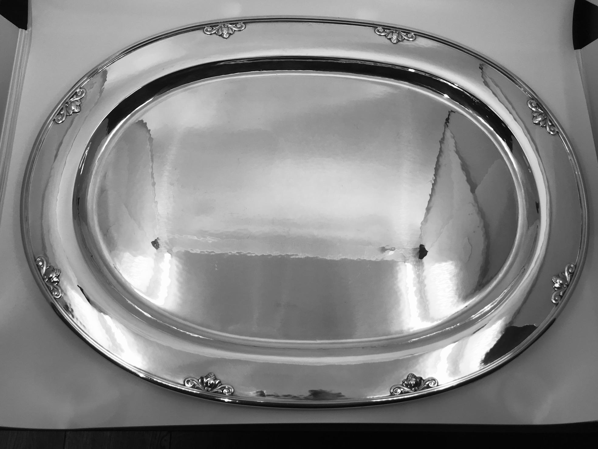 This is a large sterling silver Georg Jensen oval serving platter in the Acorn pattern, design #642H by Johan Rohde.

The Acorn flatware design is from 1915, this is one of the many serving pieces made to match.
Measures: 21 3/4? x 15 5/8? (37cm