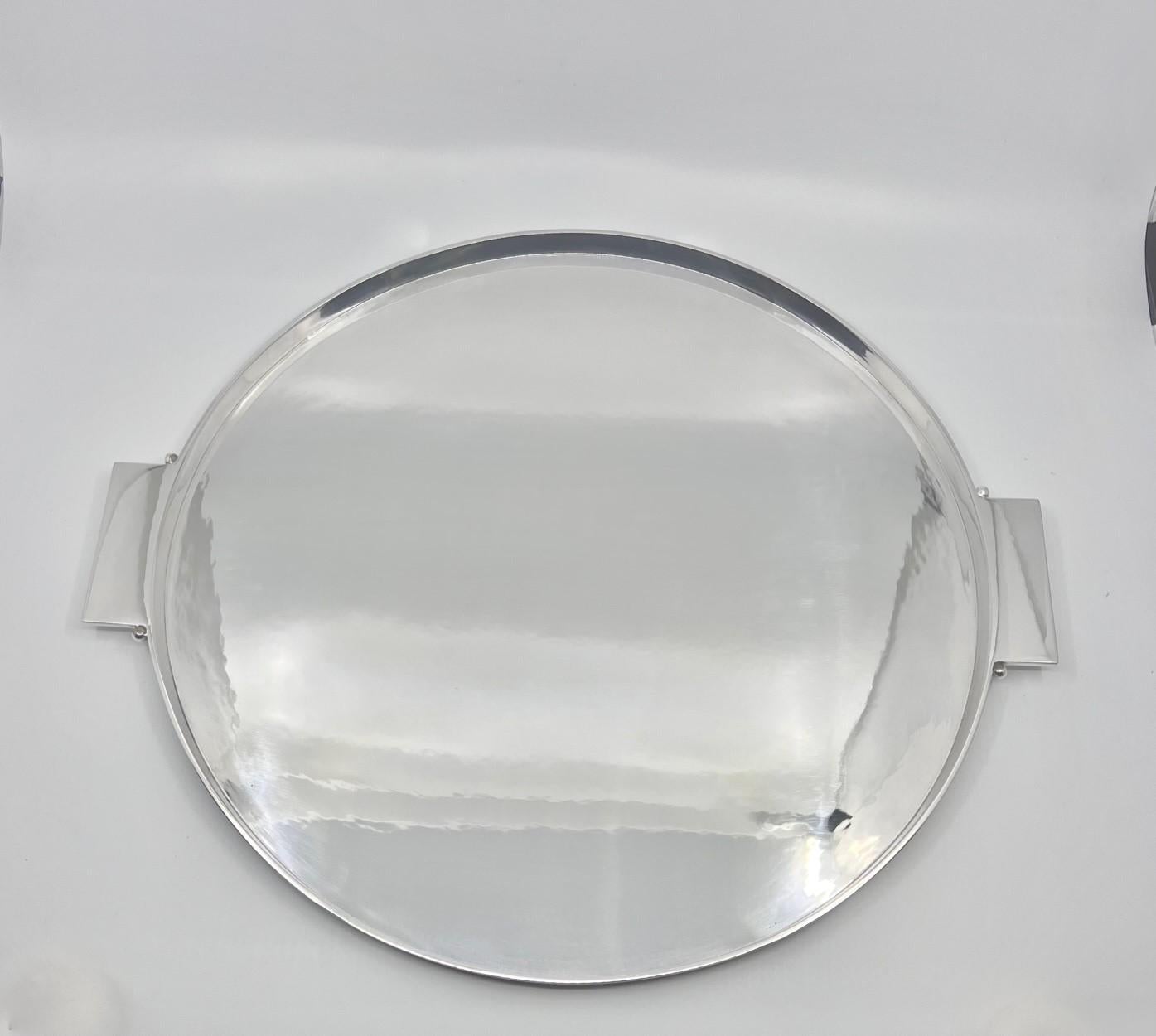 A large and heavy Georg Jensen art deco sterling silver tray #529, designed by Johan Rohde in 1928. A circular edged tray with square handles each having a single bead as design. The large tray is ideal for a tea or coffee set or as a drinks tray.