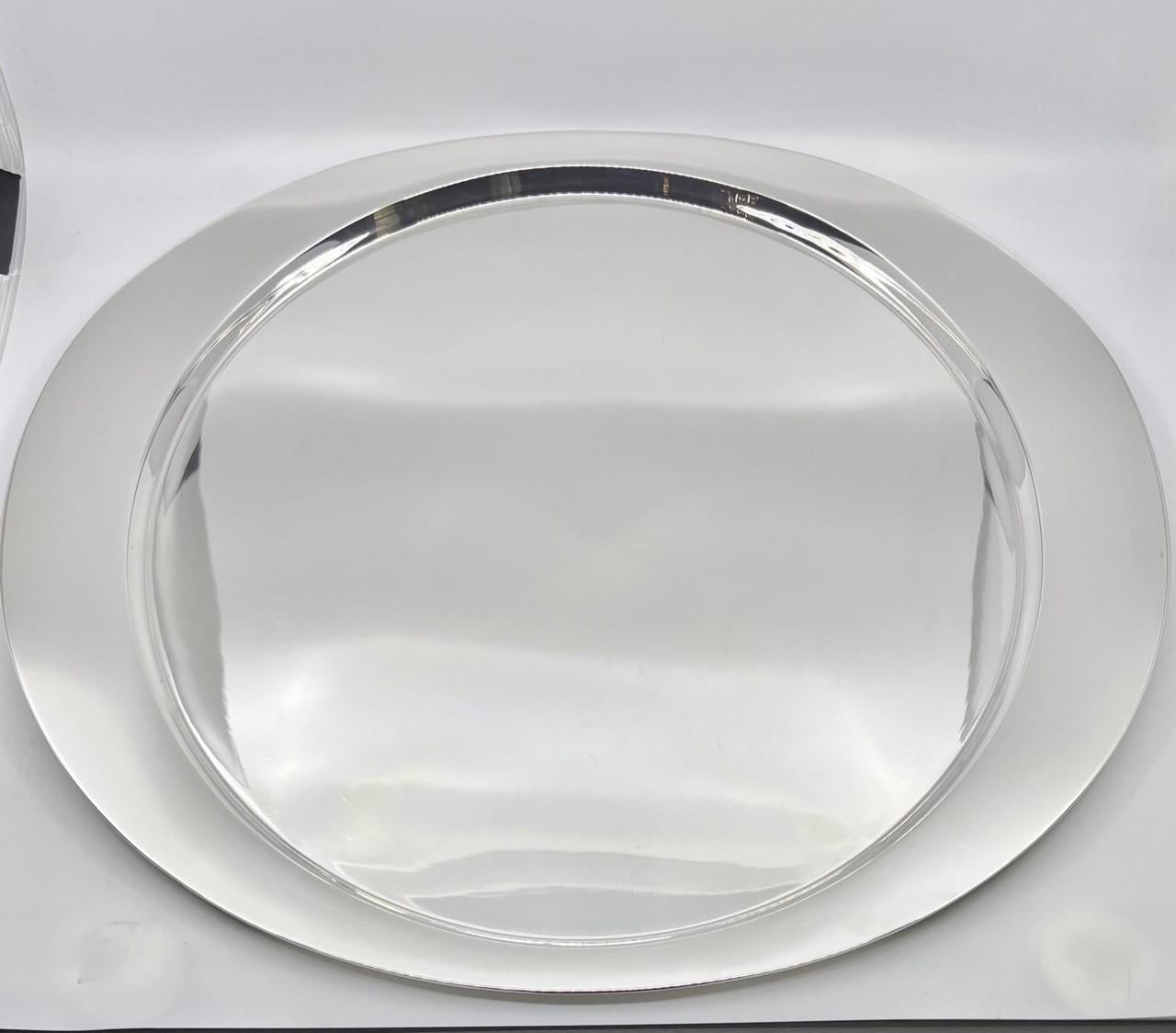 A large sterling silver Georg Jensen tray designed by Henning Koppel in 1952. A oval shaped tray with a round center. The oval edge is raised making the tray easy to lift and a very functional tray. An enormous amount of time go into making a tray