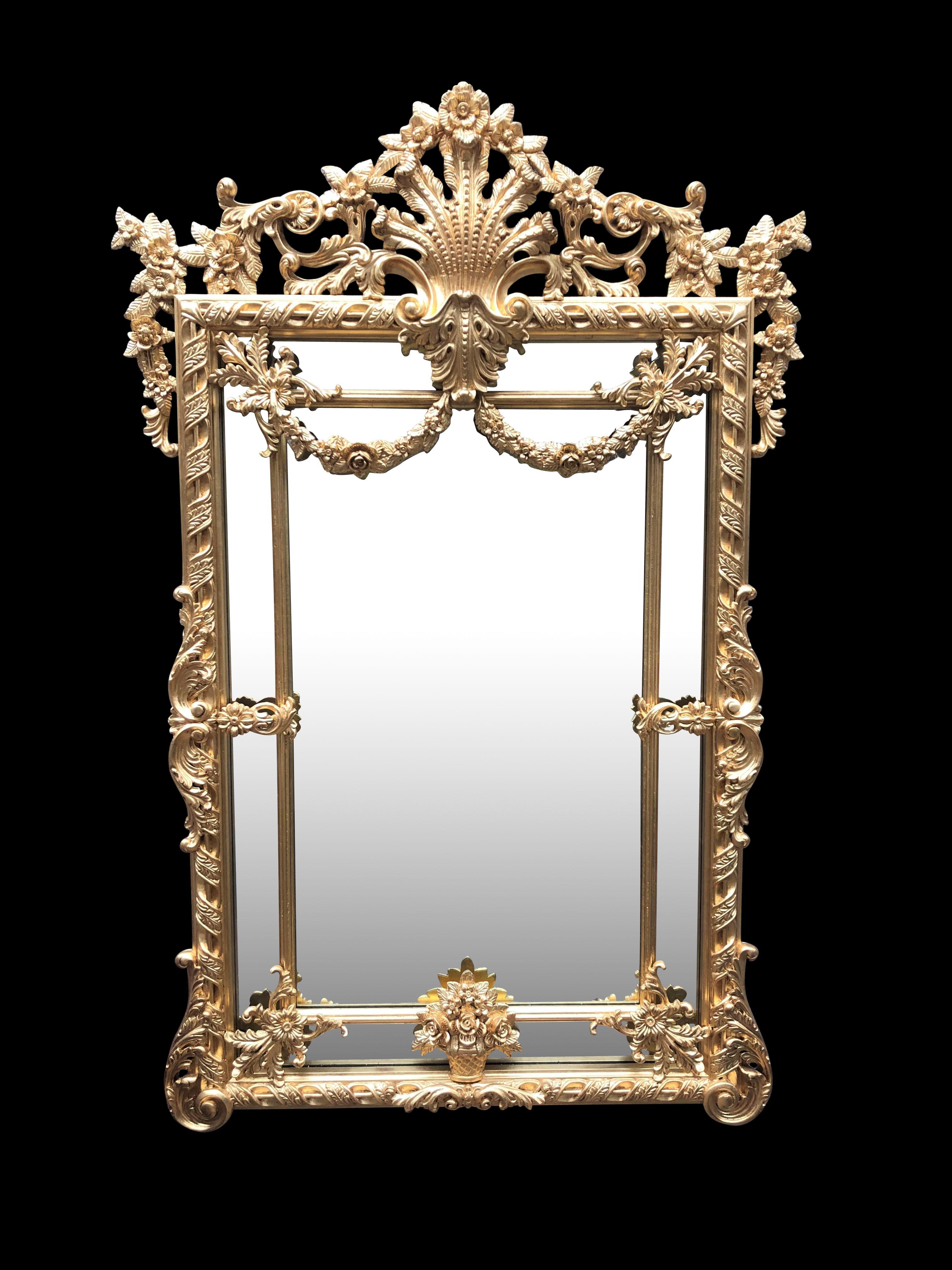 A gorgeous and large George II gilt pier mirror, carved wood, 20th century. Intricate gilt frame with Rococo motifs. Stands over 6 feet tall. Comes in excellent condition.