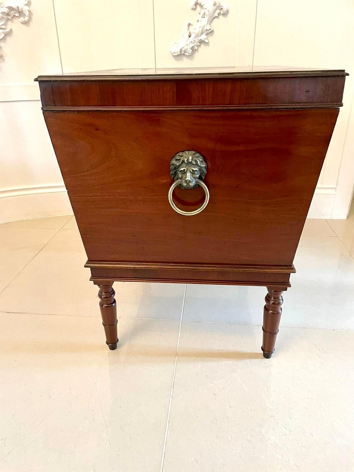 Large George III antique mahogany cellarette/wine cooler having a splendid quality mahogany lift up top with a moulded edge opening to reveal a fitted interior, original brass lions head handles. 
A superb quality figured mahogany cellarette raised