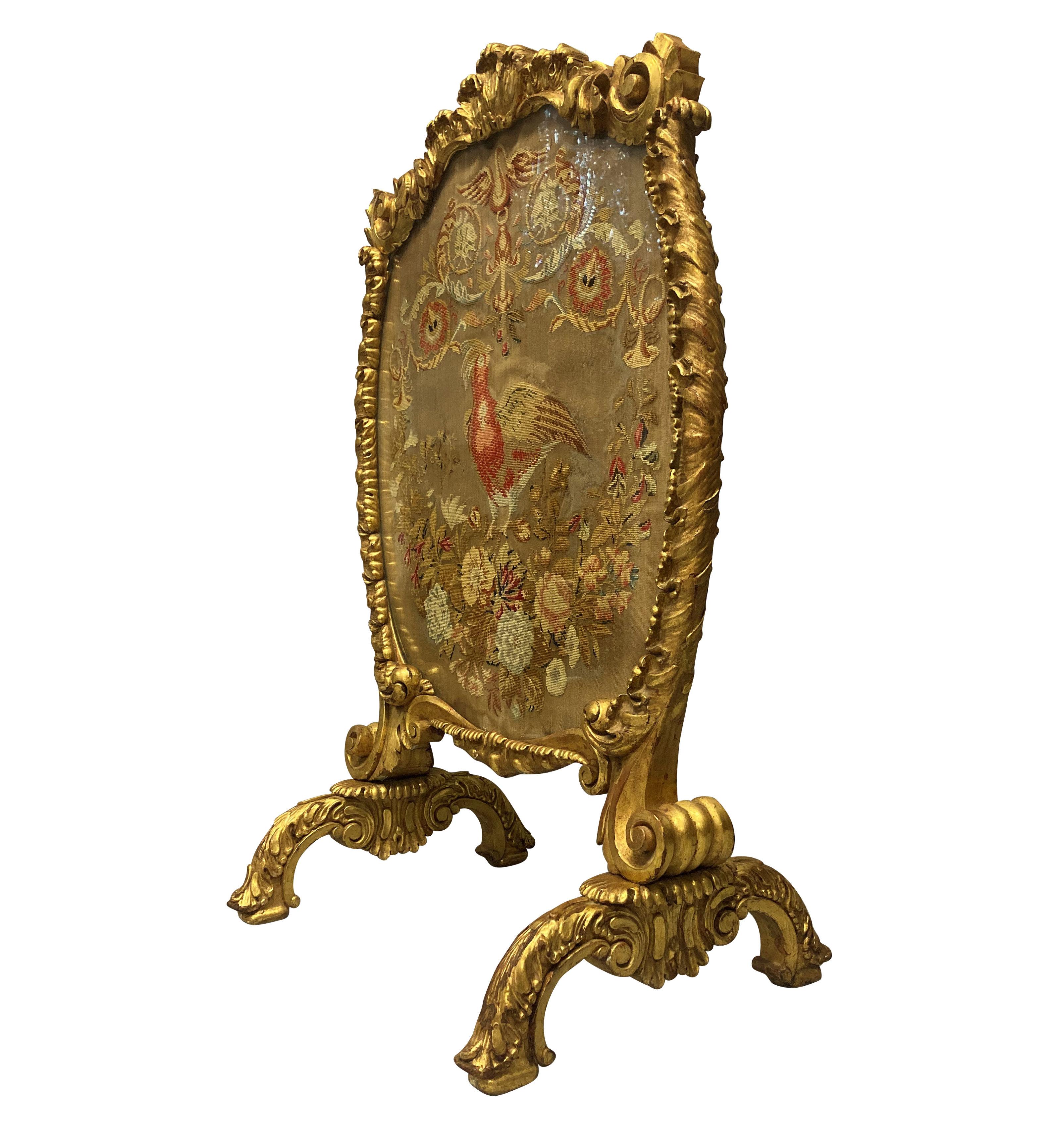 A large and finely carved George III giltwood fire screen. Containing a beautiful needlework tapestry, now under glass and the reverse of painted canvas. It is in 'Country House' condition with little or no restoration.

Full provenance available.