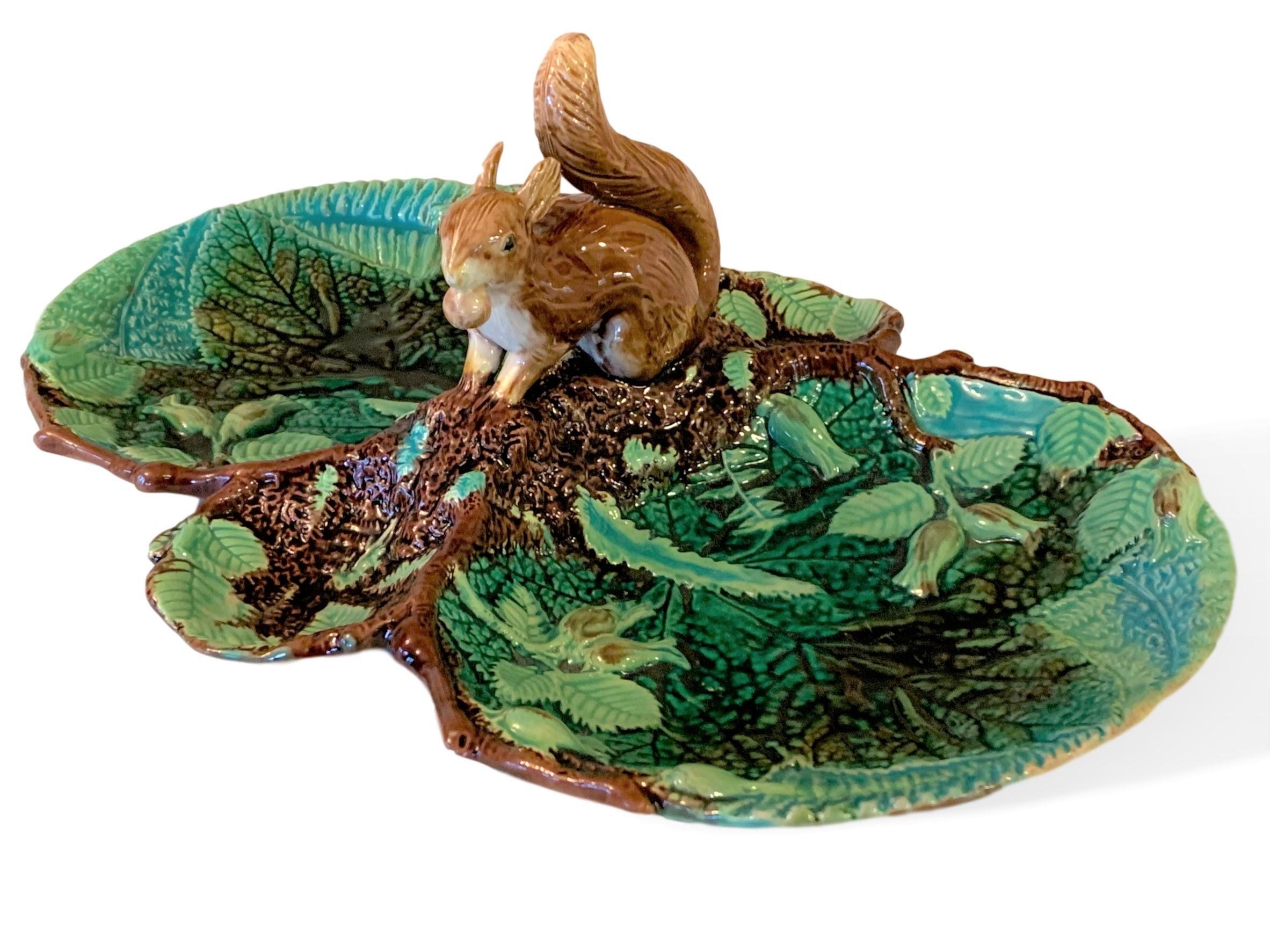 Large George Jones Majolica Quadrilobed squirrel dessert tray, English, circa 1870, molded with leaves, ferns and hazelnut blossoms, with applied naturalistic model of a crouching squirrel with a hazelnut in his mouth. This beautifully glazed and