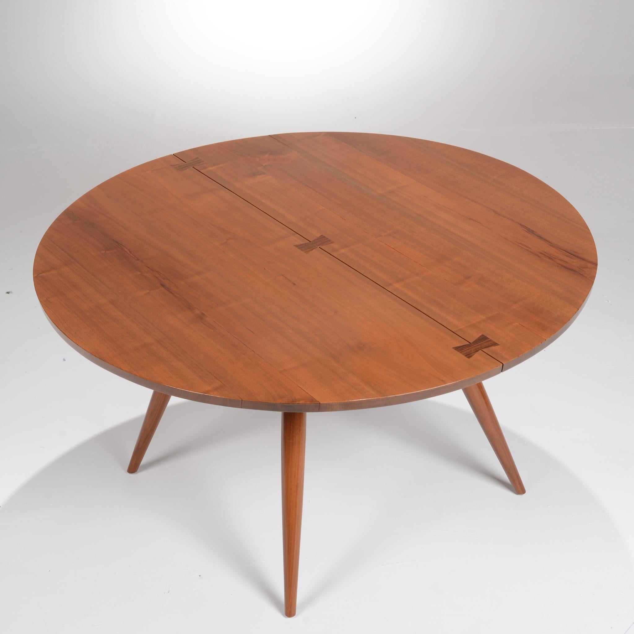 Large walnut dining table handcrafted by master designer and woodworker George Nakashima. Two semicircular solid walnut slabs connected with 3 inlaid rosewood butterfly joints. Tapered legs. 

All items are viewable at our Los Angeles Arts District