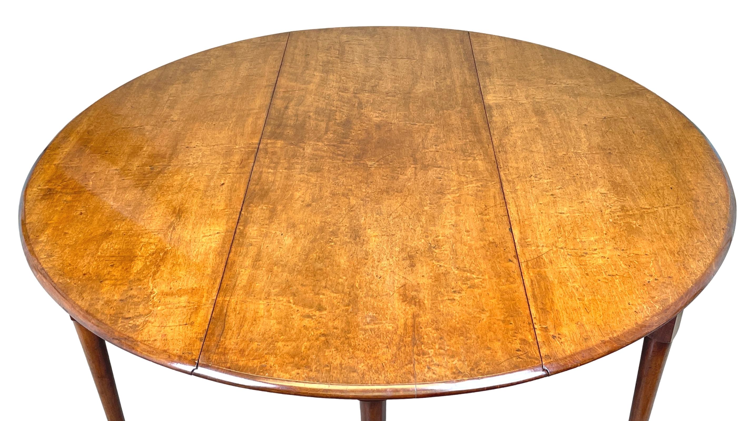 A superb mid-18th century solid Mahogany circular drop leaf dining table, to seat 8-10 people, having superbly figured top of good untouched colour and patina raised on six elegant turned legs terminating on original pad feet. 

It is most rare to