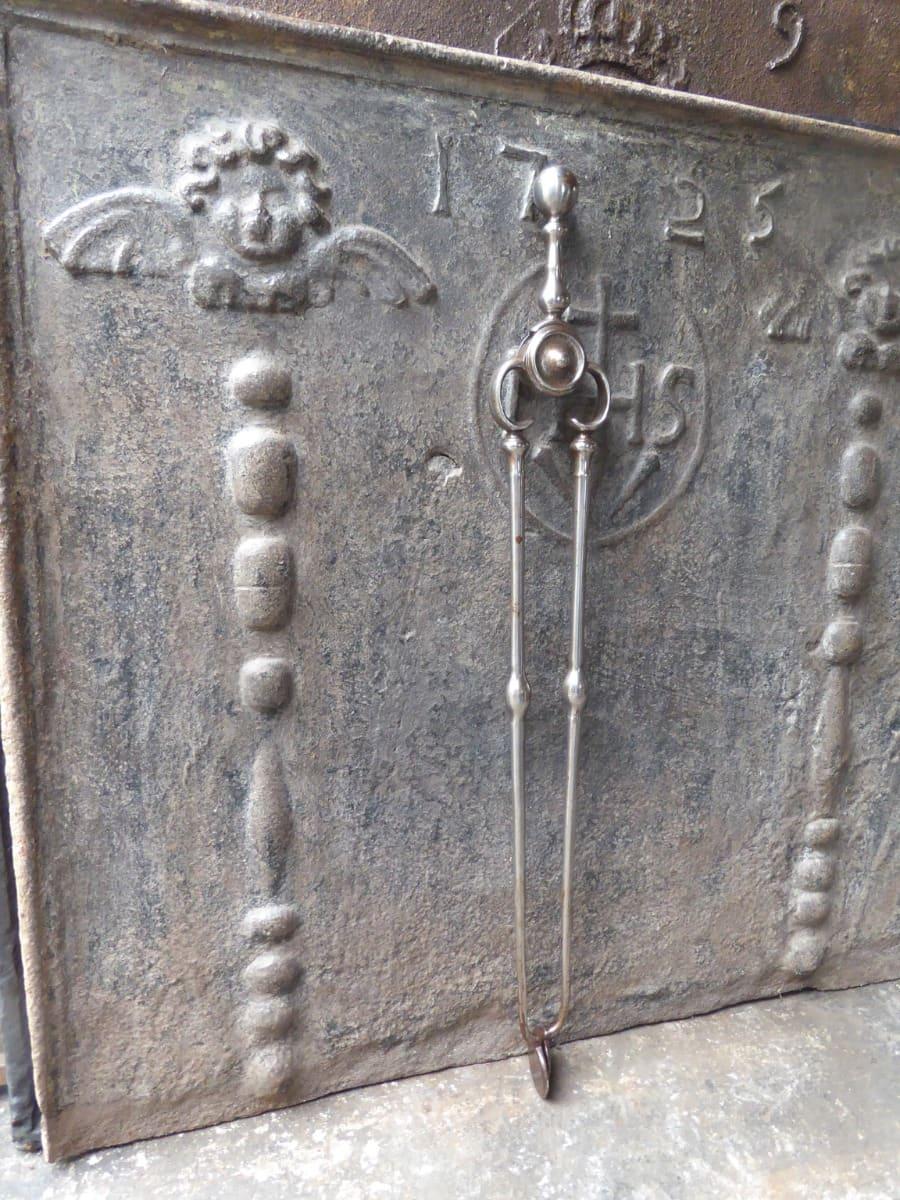 Large Early 19th Century Georgian fireplace tongs made of wrought iron. The fire tongs are in good condition and are fully functional. 