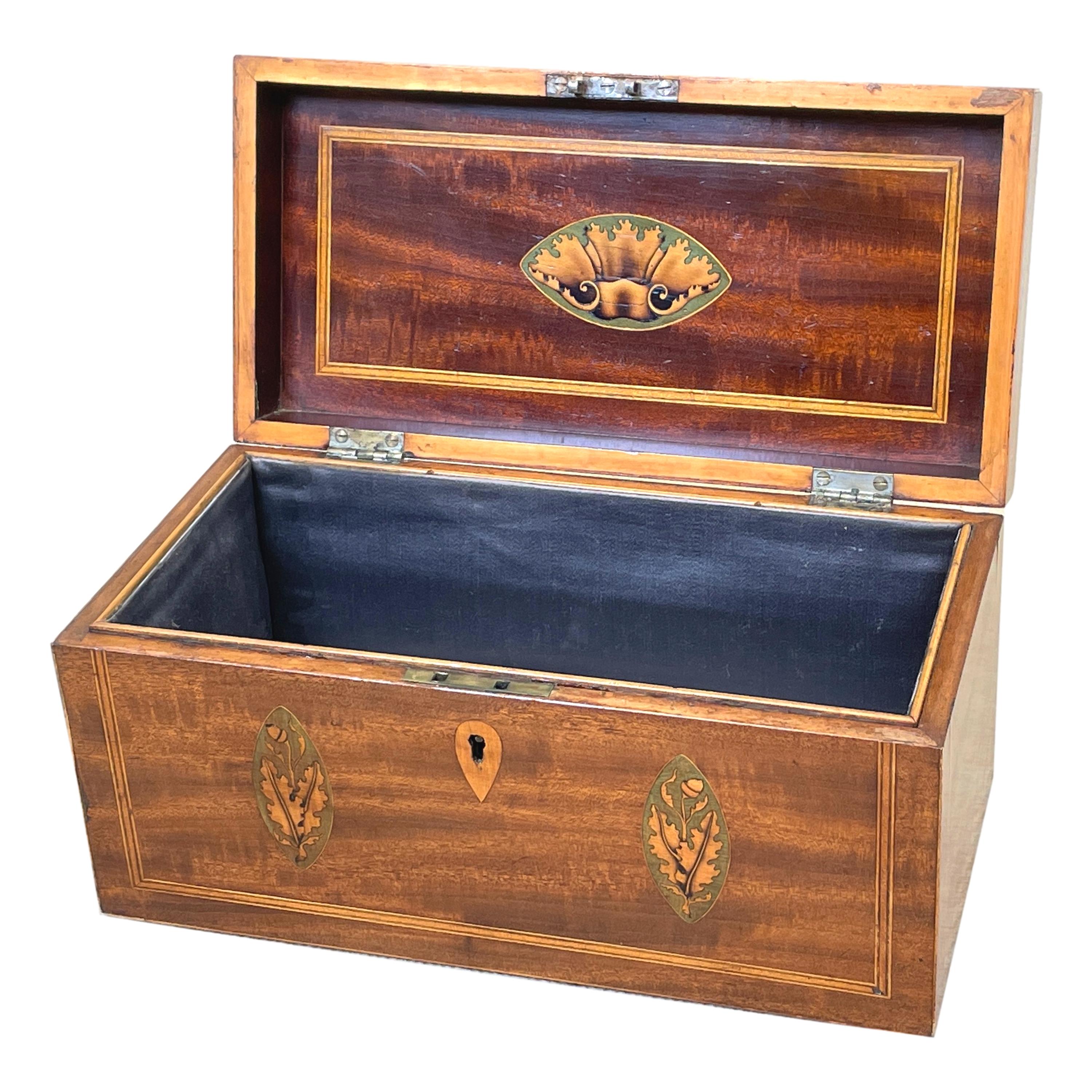 A good quality Georgian 18th century mahogany rectangular tea caddy having replacement brass axe drop handle to hinged lid enclosing cavity with attractive inlaid decoration throughout.

Tea was of course a very precious commodity throughout the