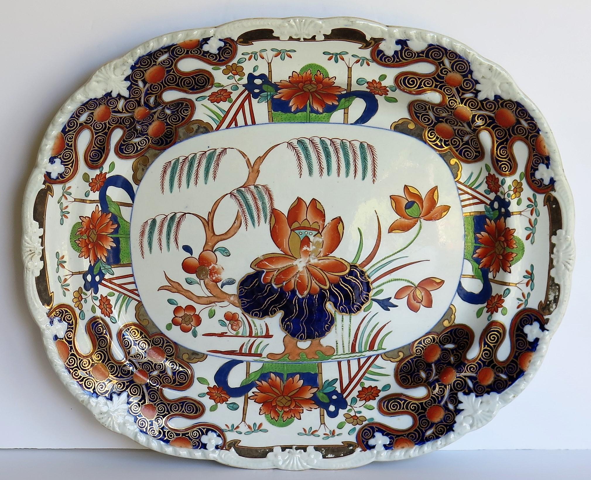 This is a beautifully hand painted large oval serving platter or meat dish in the rare Water Lily and Willow pattern by Mason's Ironstone, Lane Delph, England, dating to circa 1815.

The piece is well potted as an oval platter with a moulded edge