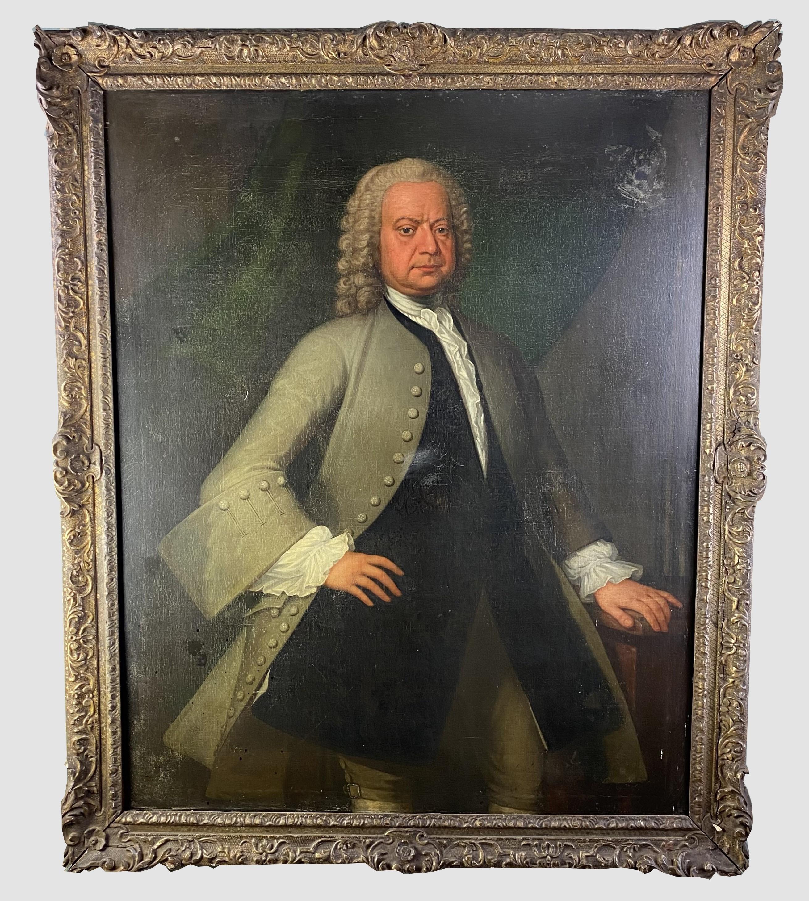 The grand Georgain oil on canvas portrait stands nearly five feet tall and depicts a handsome middle aged gentleman wearing a wig, a smart dress coat with long waistcoat and white silk ruffles at the neck and cuffs. It dates to the early half of the