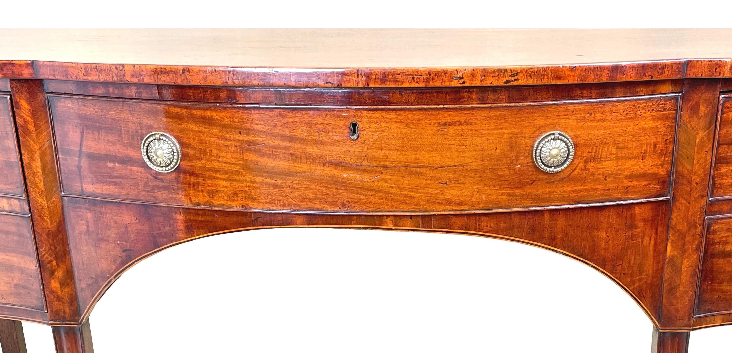 A Very Good Quality George III Hepplewhite Period Mahogany Serpentine Shaped Sideboard Having Well Figured Top Over Three Drawers With Replacement Brass Handles, Unusually With Elegant Herringbone Detailed Decoration To Stiles Raised On Square