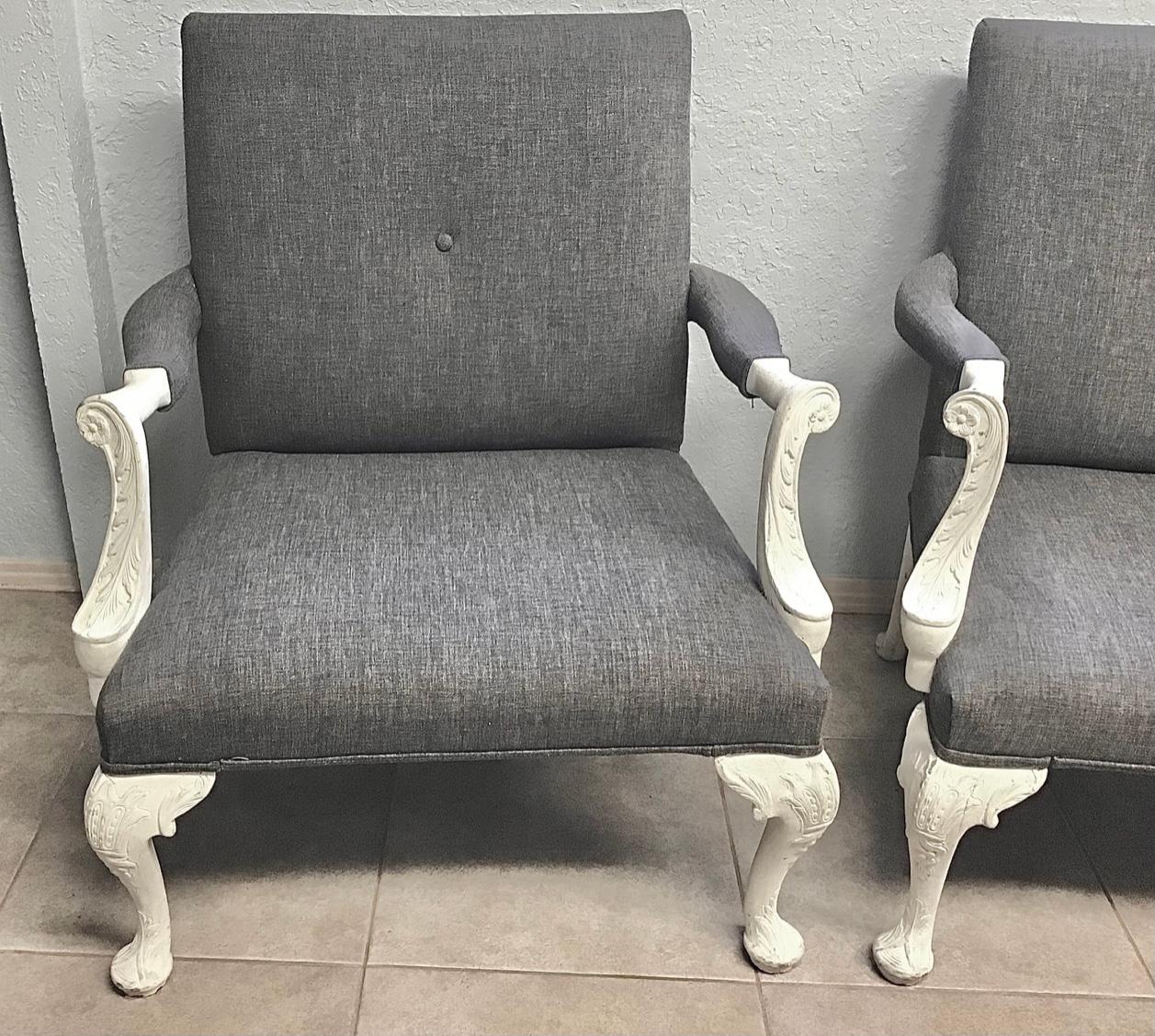 Stunning pair of Large Georgian Style library armchairs. In a matte white finish and featuring a dramatic contrasting grey upholstery. Made in the grand English Georgian taste with a painted surface now distressed to a wonderful patina. Supported by