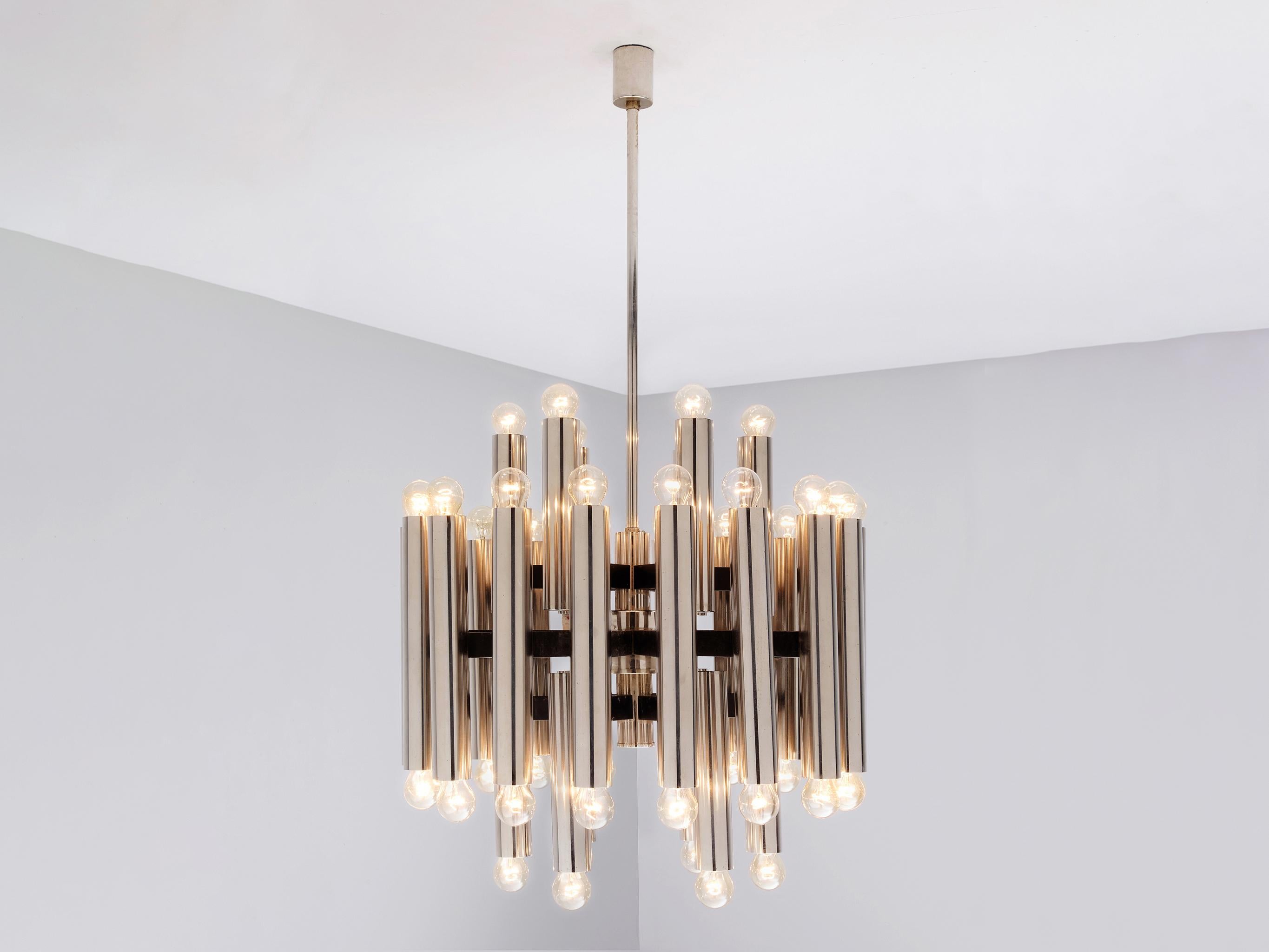 Chandelier, chrome-plated steel, coated steel, Germany, 1960s.

This design resembles the design aesthetics of Italian designer Gaetano Sciolari, known for his abundant use of metals and clean, streamlined shapes. Comprising cylindrical tubes