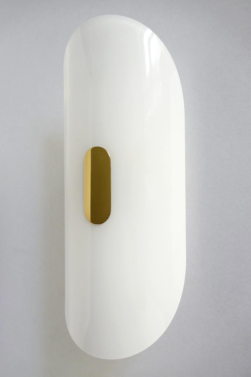 One of ... large opaline glass and brass wall light by Florian Schulz.
Germany.

Lamp sockets: 2x E27 (US E26).