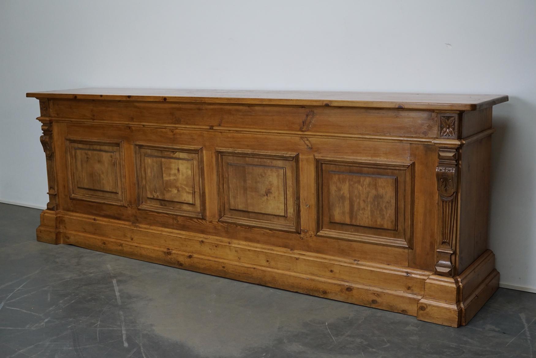 This cabinet was produced during the early 20th century in Germany. This piece features 16 large drawers with nice pine knobs. The back of the cabinet is paneled as it was used as a shop counter. The interior dimensions of the drawers are: DWH 32 x