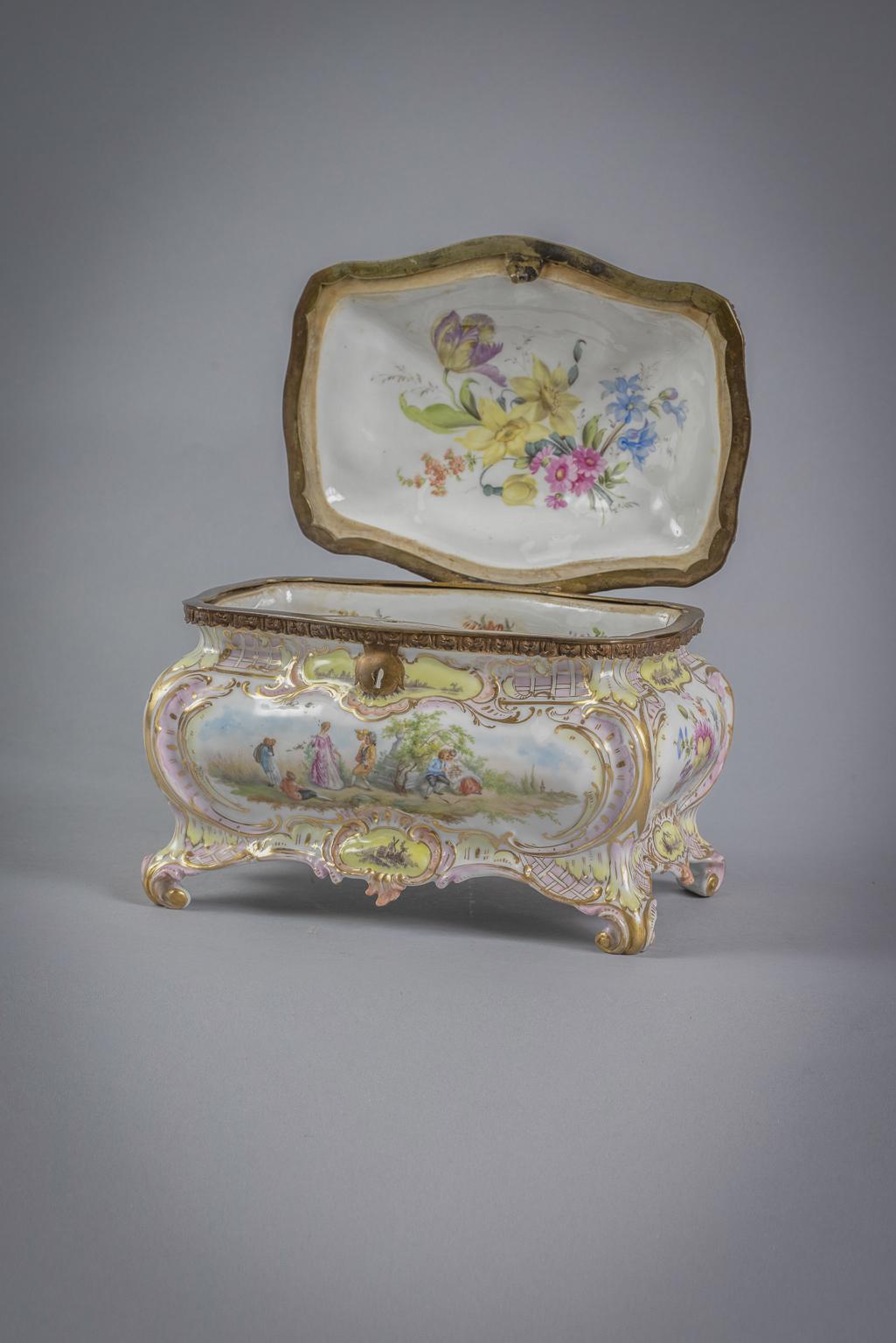 Reserves painted with figures in landscapes alternating with floral reserves, edged in gilded scrolls, the interior with full blown floral decoration.