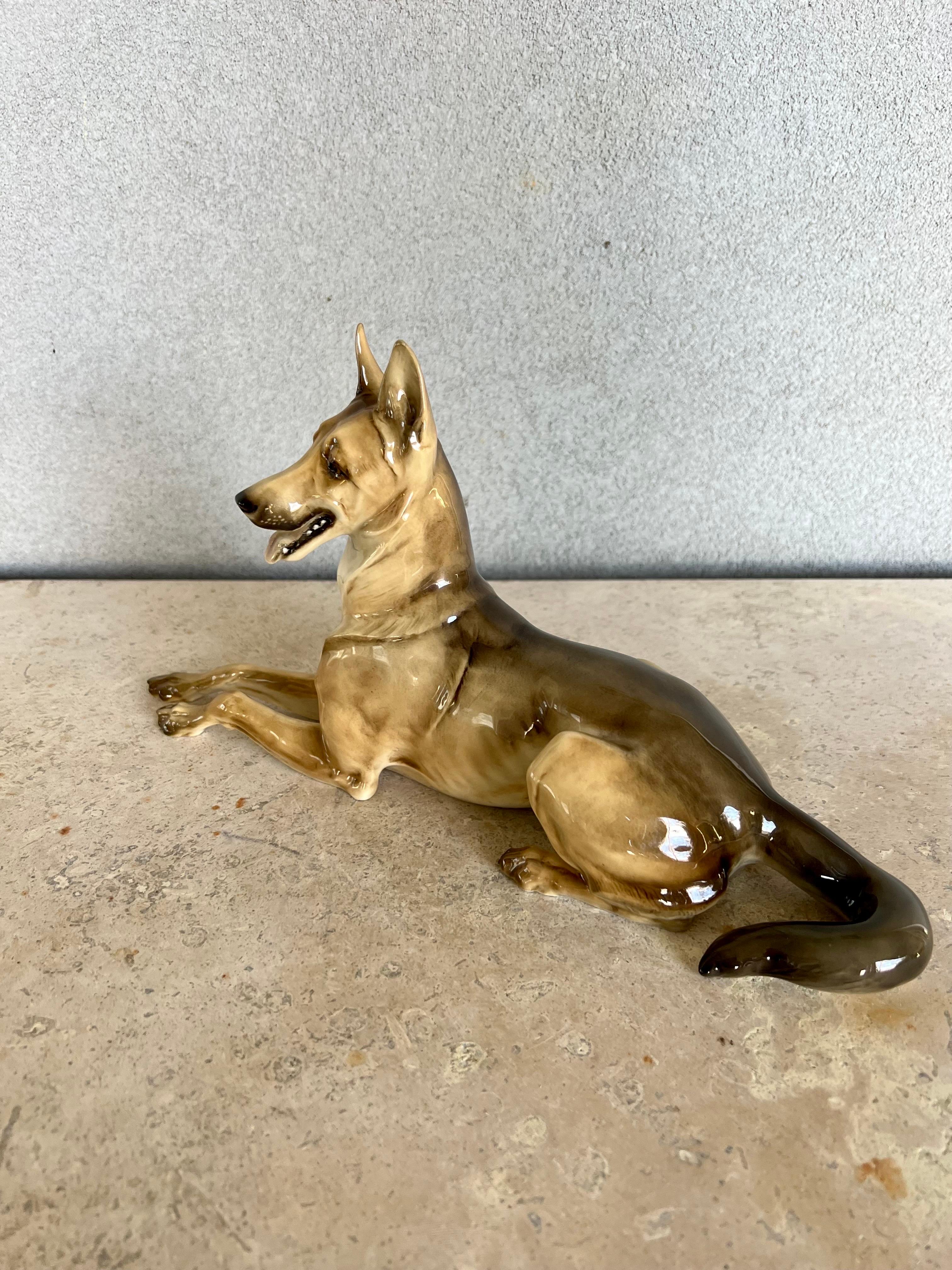 Exquisite porcelain German Shepherd Dog, hand-Painted, very detailed. 
has a glazed finished that gives the dog a very beautiful and sharp look.
Has manufacturer stamp on bottom.