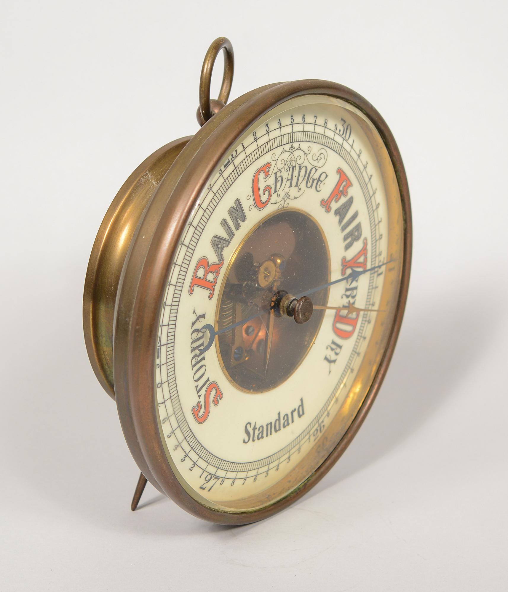 Early 20th century German aneroid barometer. This barometer has an enamelled face. The workings in the interior are of high quality. The barometer is large with an 8 inch diameter face. This can stand on a desk or table and can also be hung on a