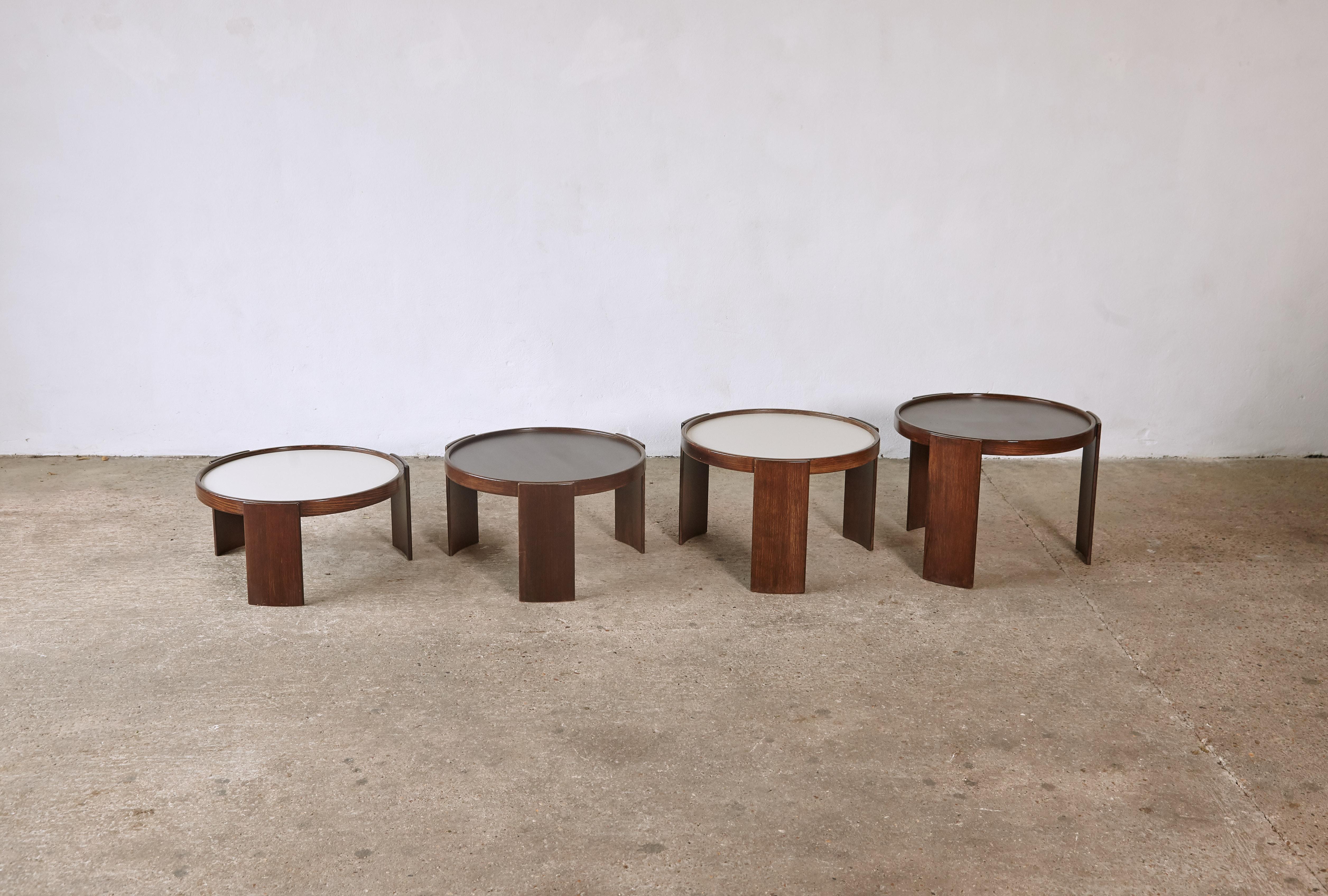 Larger than normal size Gianfranco Frattini stacking nest of tables for Cassina, Italy, 1970s. Wooden frames and reversible laminate tops (reversible from brown to white). With Cassina makers labels. Good condition with minor blemishes relative to
