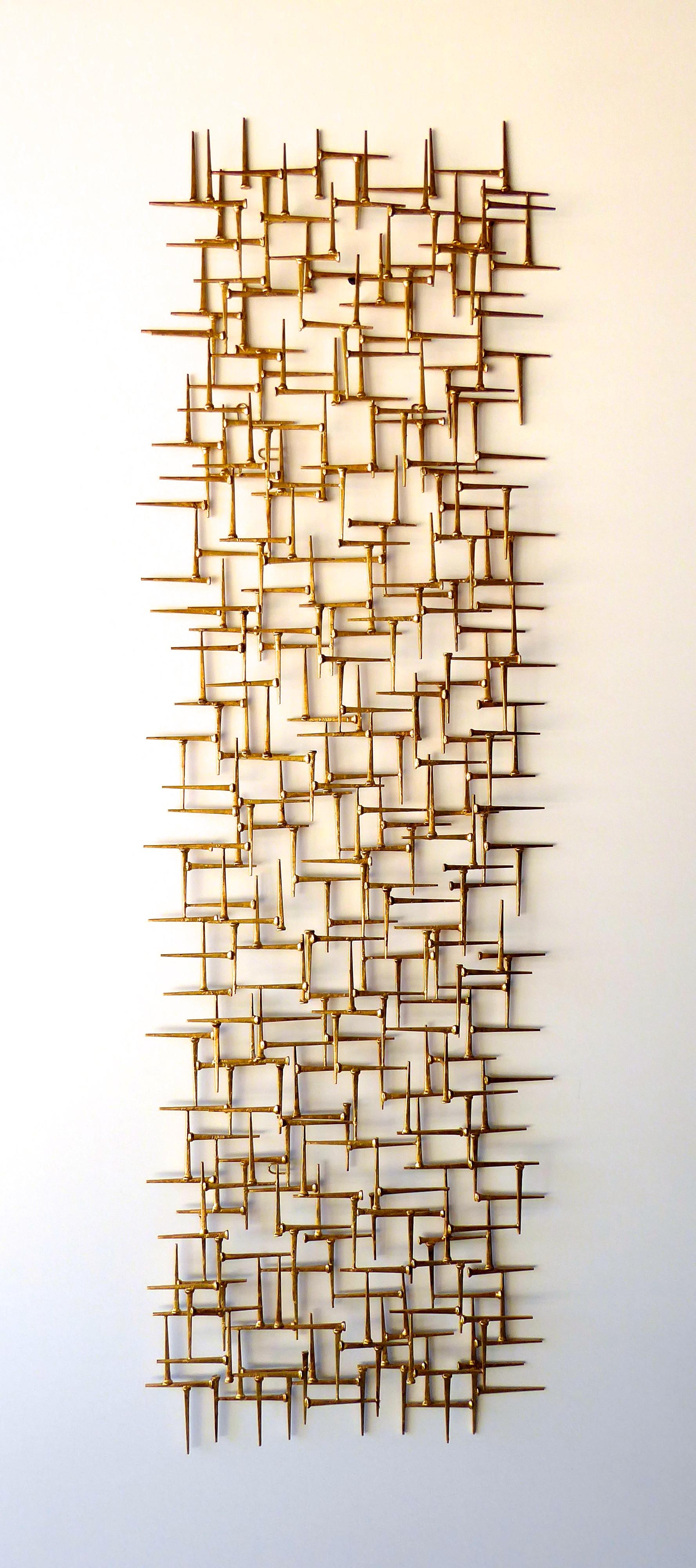 A large gold-leafed metal rectangular wall sculpture by contemporary American artist Del Williams. The sculpture is a modern take on midcentury but would work well in any type of interior. It can be hung either vertically or horizontally.