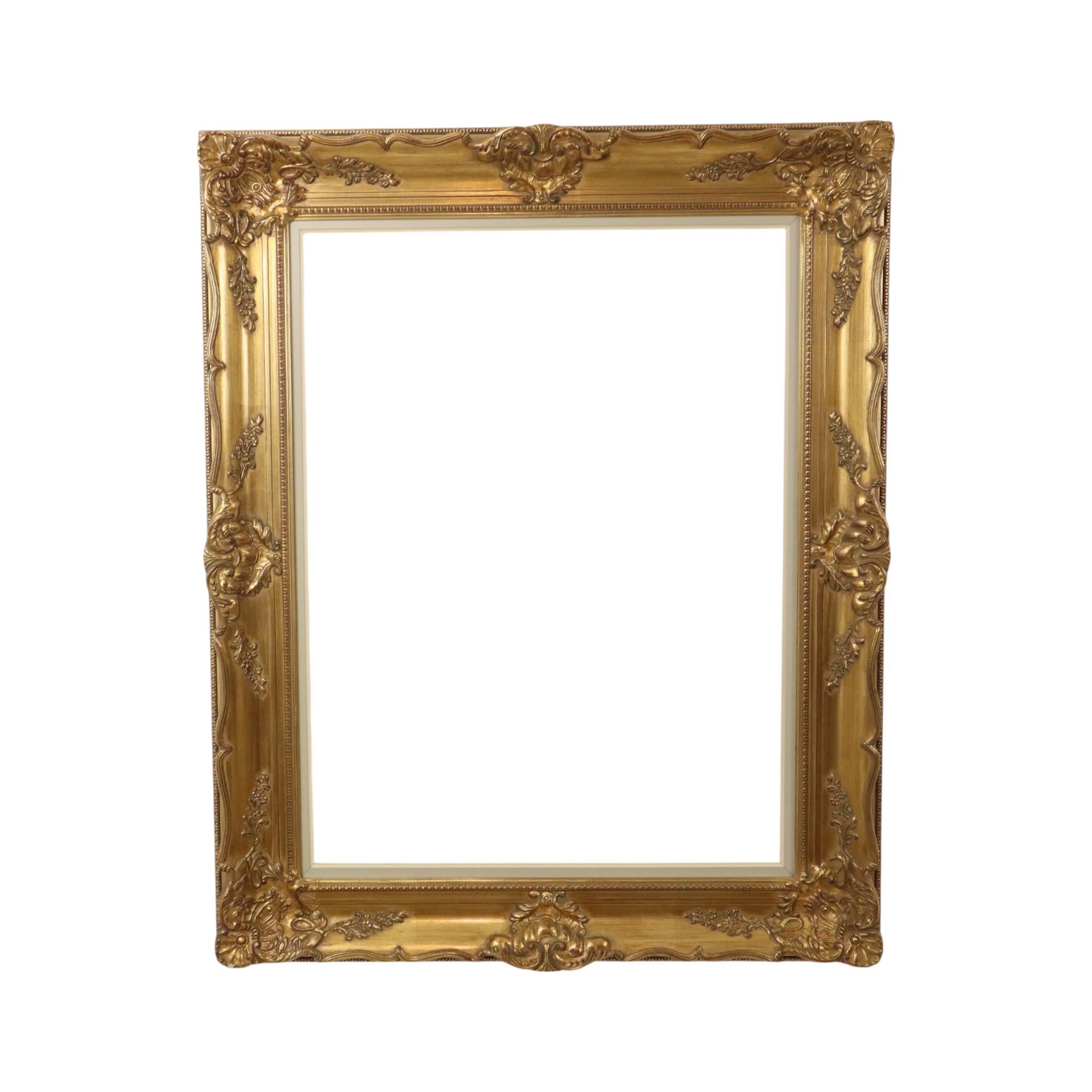 Large, gilded vintage pine frame with beautiful age patina, XL size, entirely in classic Baroque style, decorated with elegant acanthus leaves, vines, and patterns all around. Impressive XL size, circa mid-20th century.

A lovely frame size for