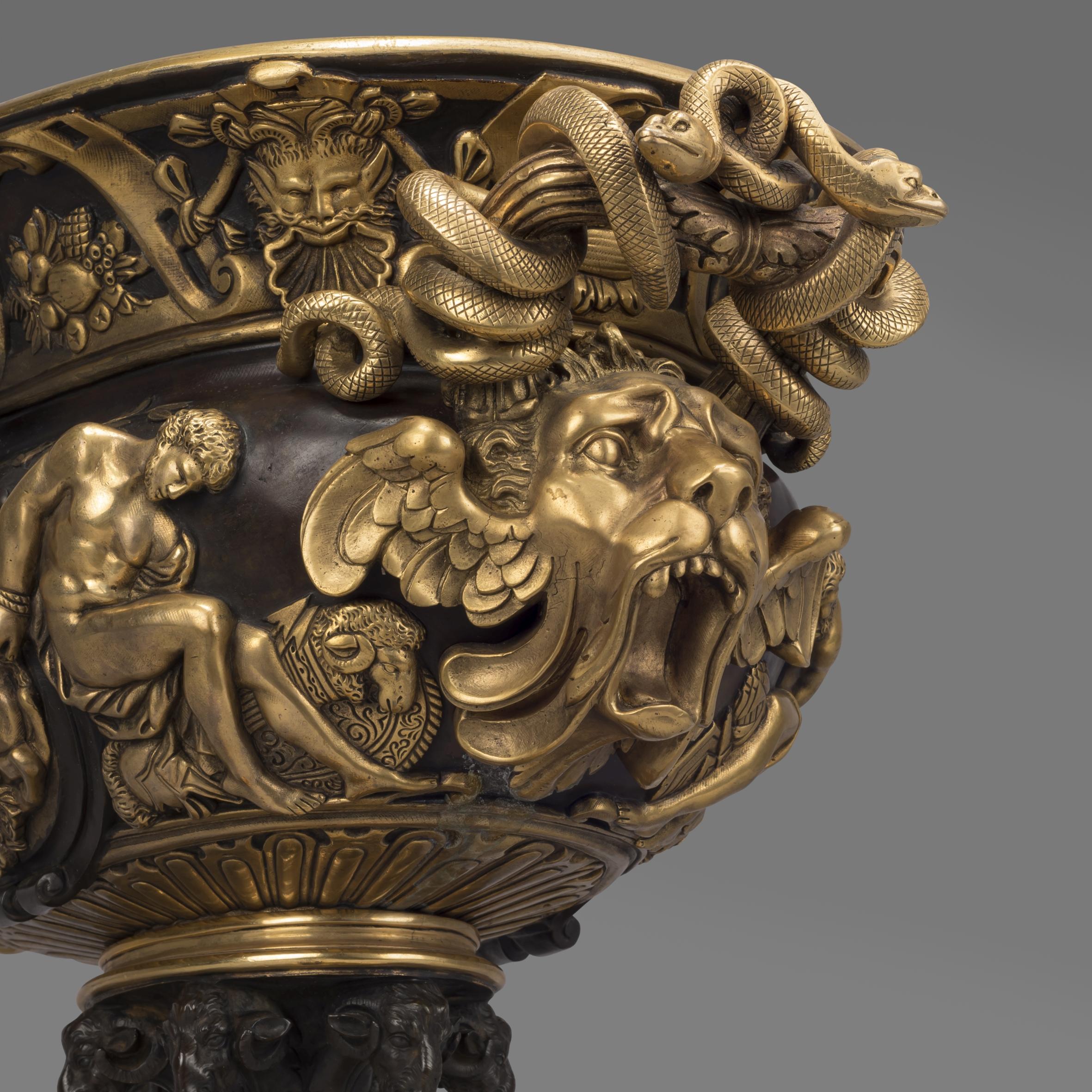 A large and finely cast gilt and patinated bronze neoclassical style vase.

This impressive vase is of oval shape with gilt and patinated bronze decoration of classical figures and motifs. The handles formed as entwined snakes and winged lion