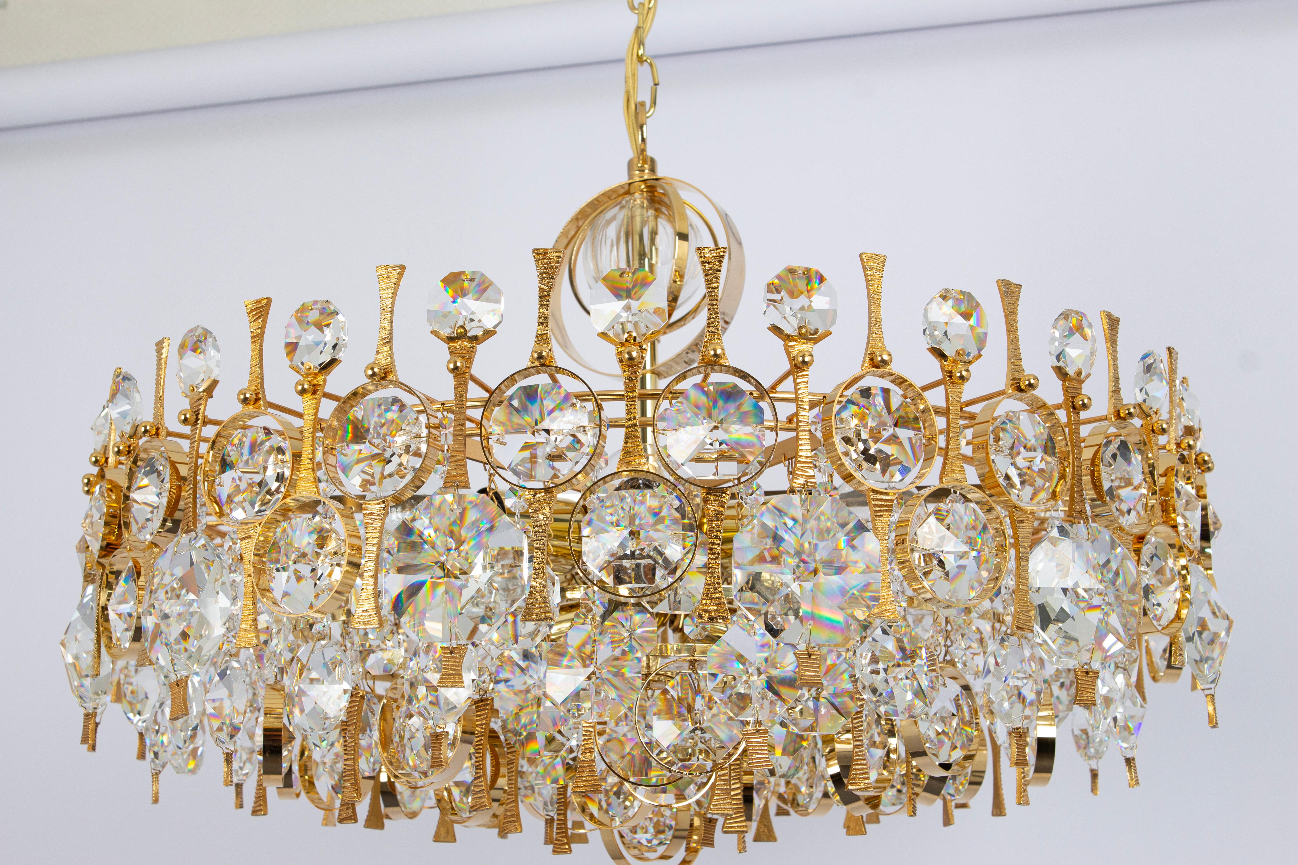 An outstanding and high-quality gilded chandelier or pendant light fixture by Palwa, Germany, 1970s.

It is made of a 24-carat gold-plated brass frame decorated with individual 