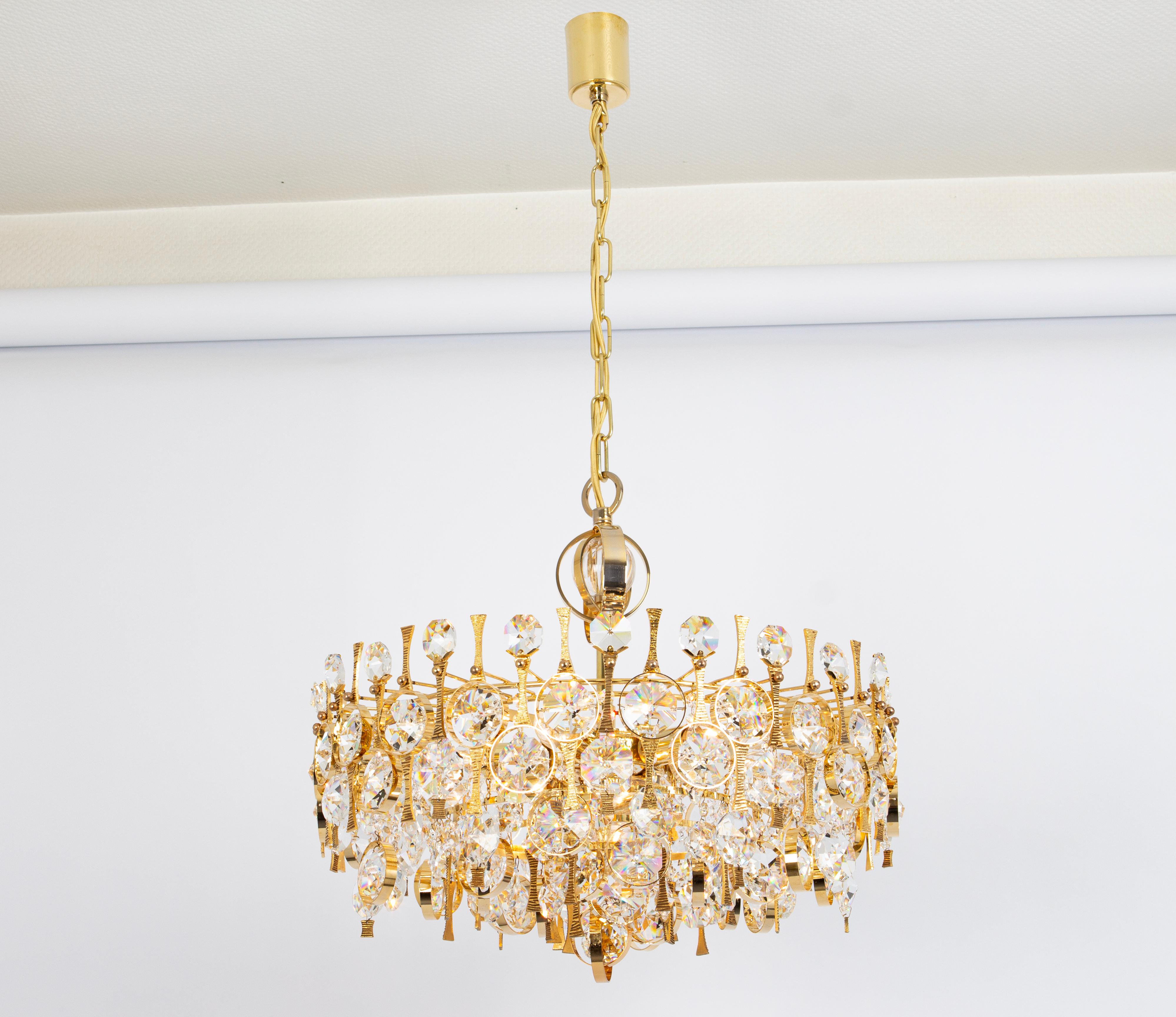 An outstanding and high-quality gilded chandelier or pendant light fixture by Palwa, Germany, 1970s.

It is made of a 24-carat gold-plated brass frame decorated with individual 