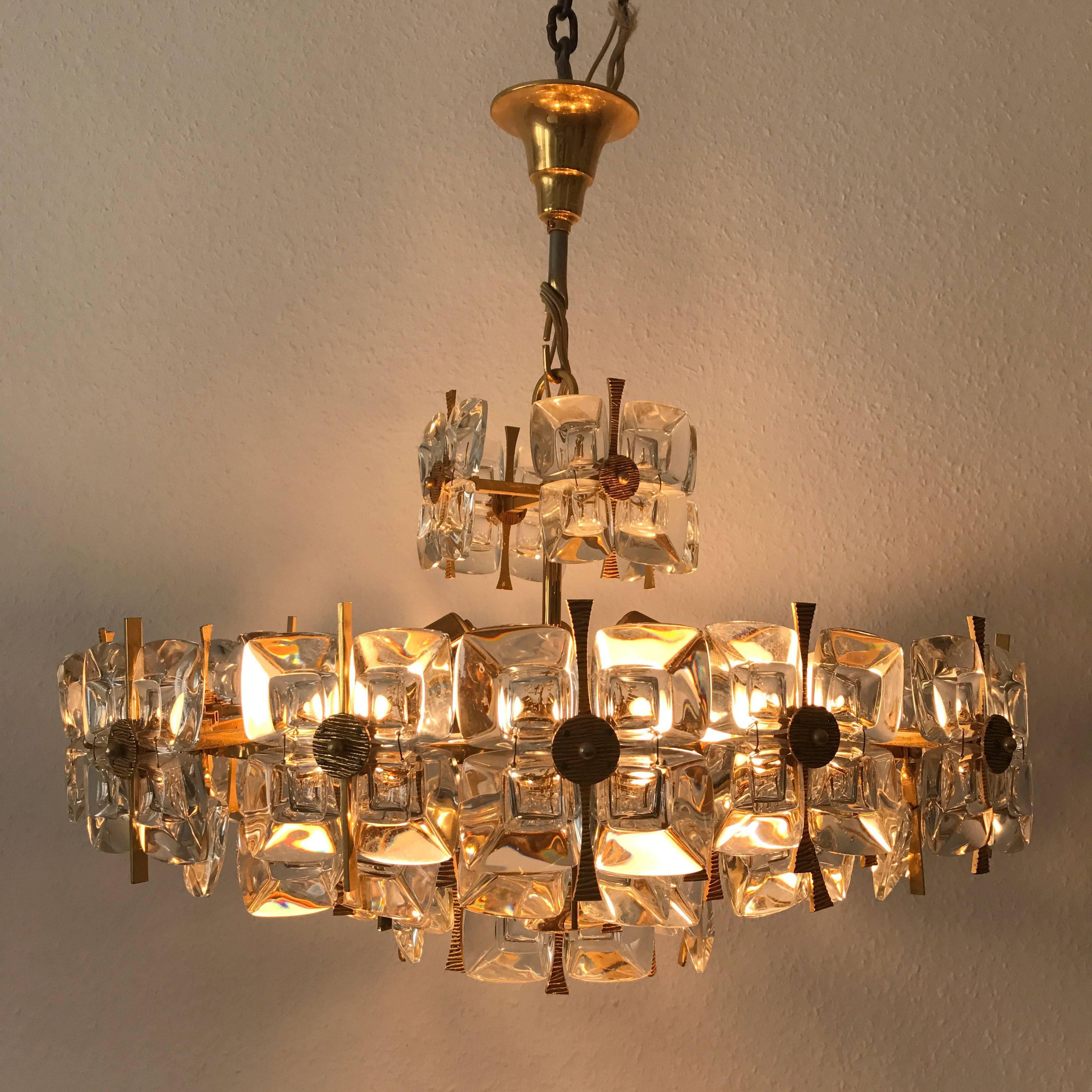 Exceptional, extremely rare and large Mid-Century Modern chandelier or pendant lamp, executed in gilt brass and large glass elements. Manufactured by Palwa, Germany in 1970s.
The chandelier needs nine Edison screw fit bulbs (Six E27 and three E14).